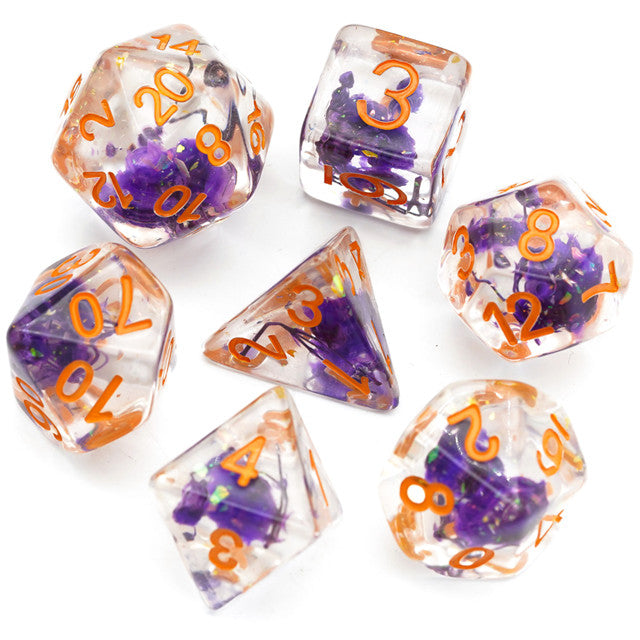 Purple Flower Dice Set - Type 2 - Clear dice set with embedded purple flowers and bright orange numbers, includes d20, d12, d10, d8, d6, d4, and percentile.