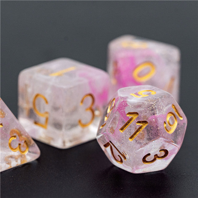 Pink Swirl and Glitter Dice Set - Pink swirl and glitter d20 and d6 dice with gold numbering on black background.