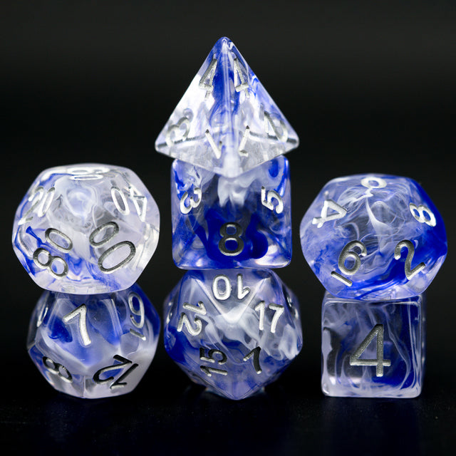 Blue Smoke Dice Set - Seven translucent blue and clear polyhedral dice with white numbering, each with a smoky swirl pattern inside.