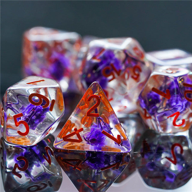 Purple Flower Dice Set - Type 2 - Purple and clear resin dice set with red numbering and embedded flower petals, including a tetrahedral die.