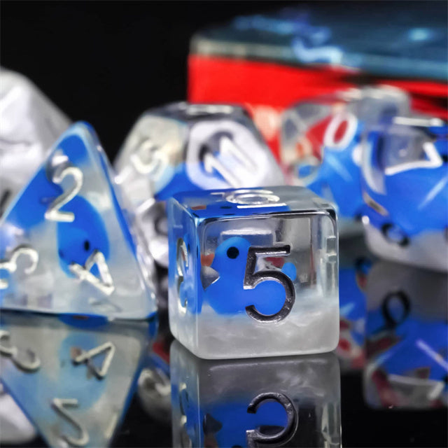 Blue Duck Dice Set - Translucent blue and clear plastic dice set with white numbers, including a d20, d10, d8, d6, and d4.