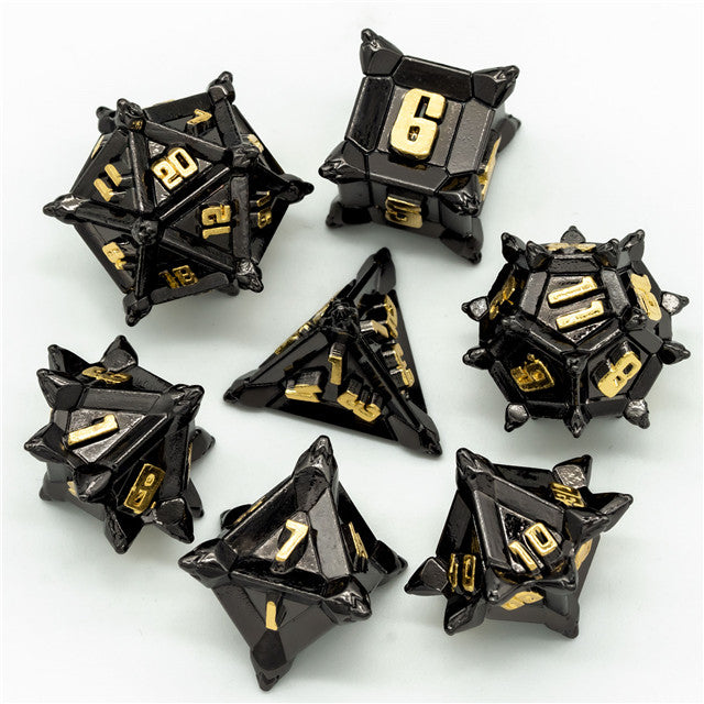 Caltrop Black Metal Dice Set - Set of seven black metal caltrop dice with gold numbers, each featuring sharp, angular spikes and geometric shapes.