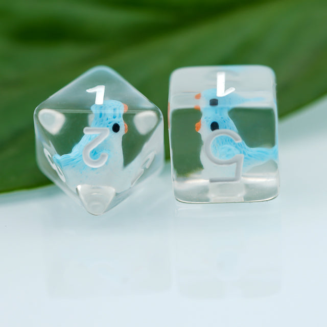 Blue Bird Dice Set - Transparent dice with blue bird illustrations and white numbers inside clear resin cubes.