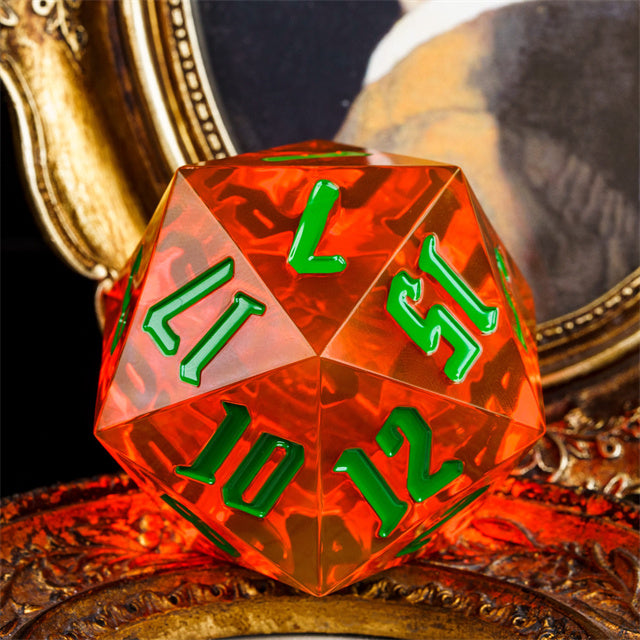 Giant 55mm D20 - Orange - Giant transparent orange acrylic 55mm d20 dice with neon green numbers on ornate surface.