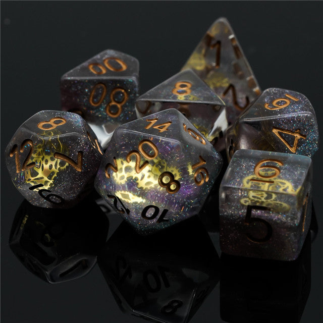 Mini Gears Dice Set - Set of six translucent black polyhedral dice with gold numbers and intricate gold gear designs inside each die.