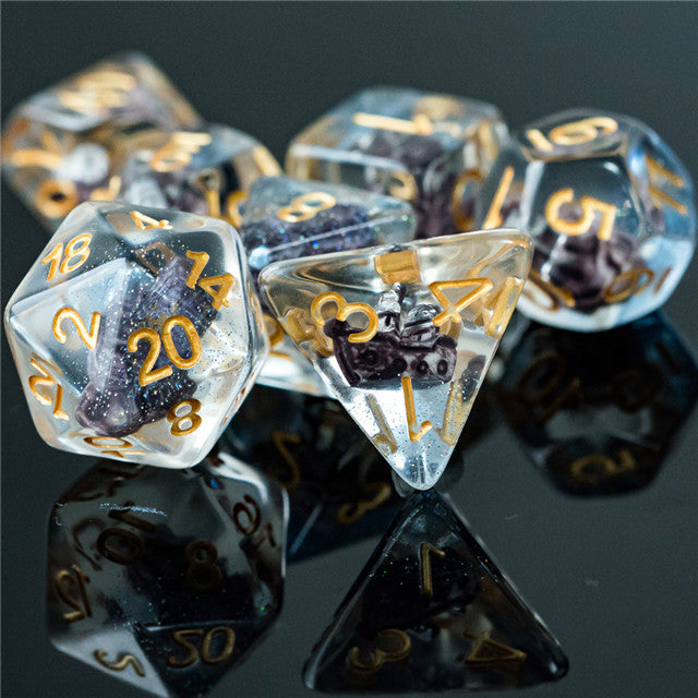 Boat Dice - Clear polyhedral dice set with gold numbers and tiny black boat inclusions inside.