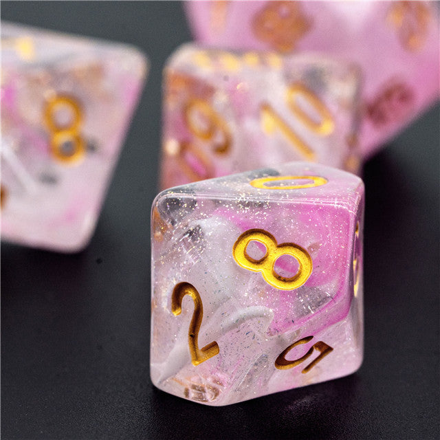 Pink Swirl and Glitter Dice Set - Pink and clear resin dice with gold numbers, featuring glitter and swirl patterns.