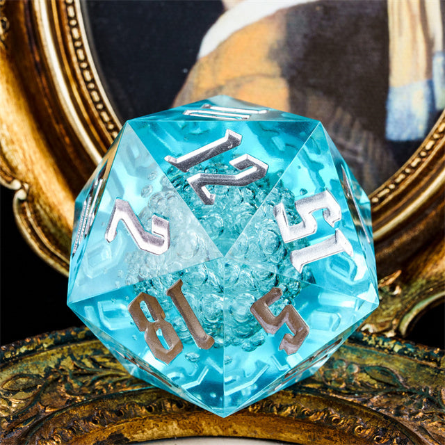 Giant 55mm D20 - Blue Bubbles - Giant 55mm translucent blue acrylic d20 dice with silver numbers and bubble inclusions inside.