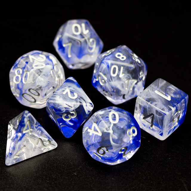 Blue Smoke Dice Set - Seven translucent blue polyhedral dice with white and black numbering, featuring smoky swirling patterns inside each die.