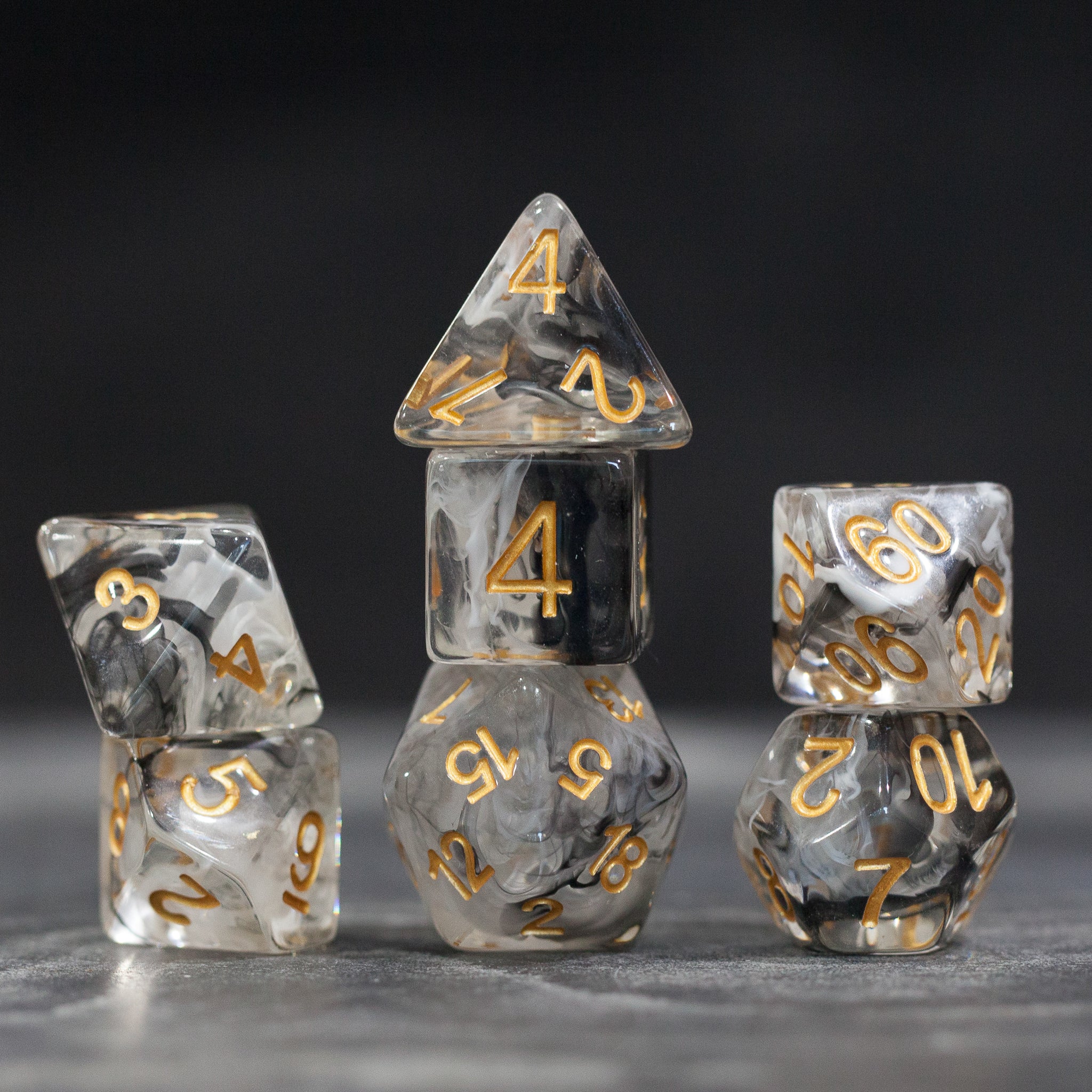 Black & White Smoke Dice Set - Set of black and white smoke dice with gold numbers including d4, d6, d8, d10, d12, and d20.