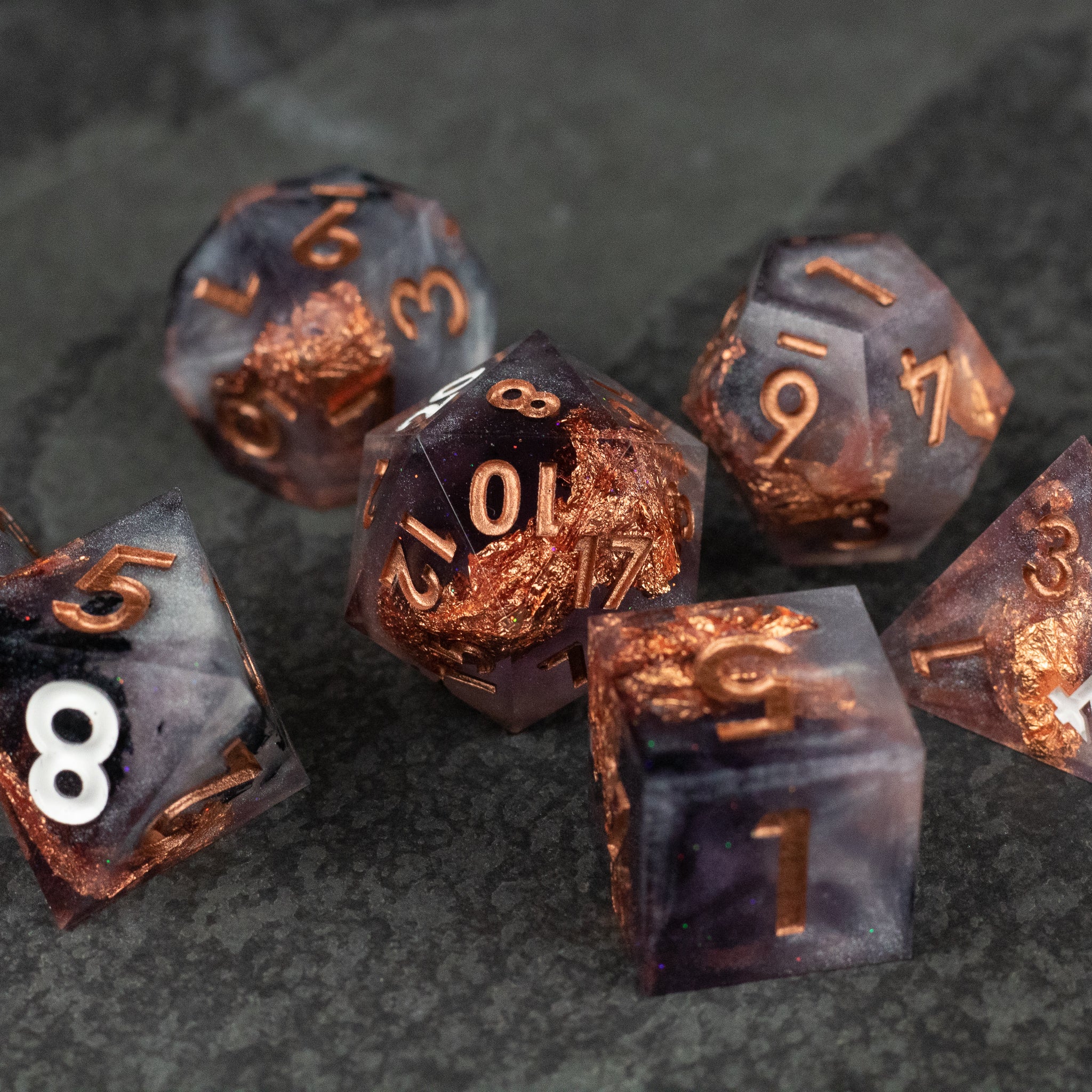 Lich King Dice Set - Set of translucent black and copper sharp-edged polyhedral dice with metallic copper numbering.