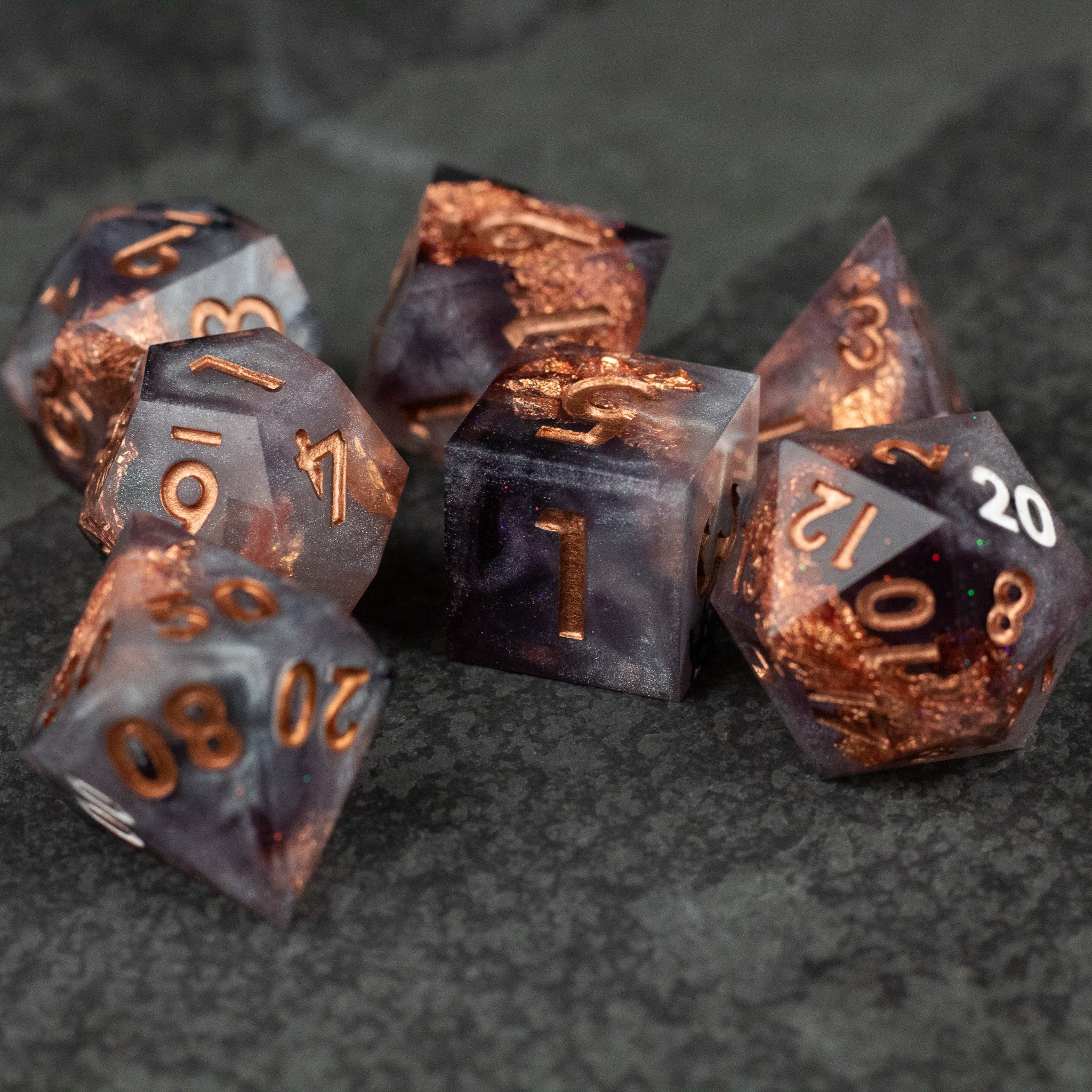 Lich King Dice Set - Metallic copper and black sharp-edged polyhedral dice with engraved numbers for tabletop gaming.