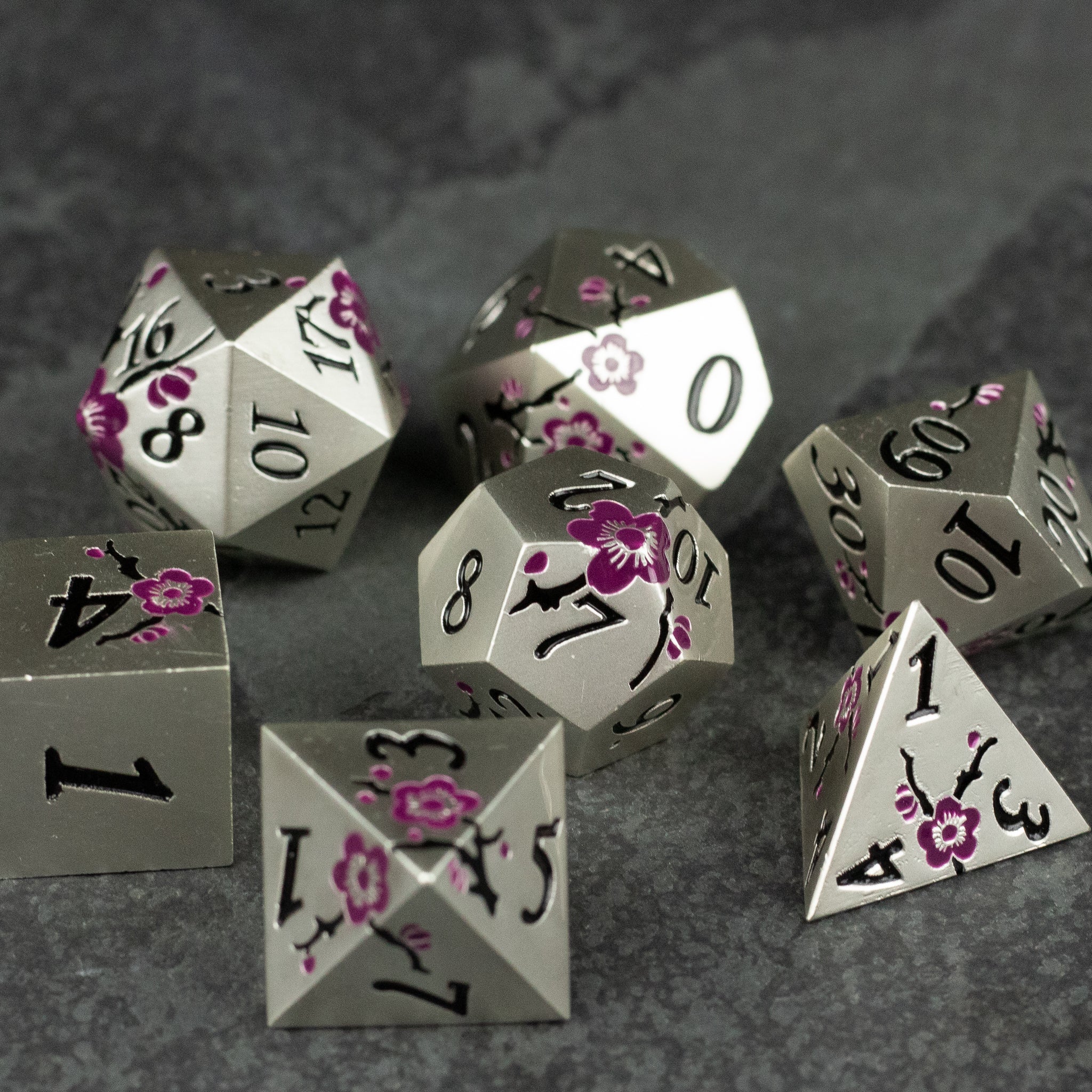 Silver & Maroon Metal Flower Dice - Set of silver metal polyhedral dice with maroon floral designs and black numbering, including d20, d12, d10, d8, d6, and d4.