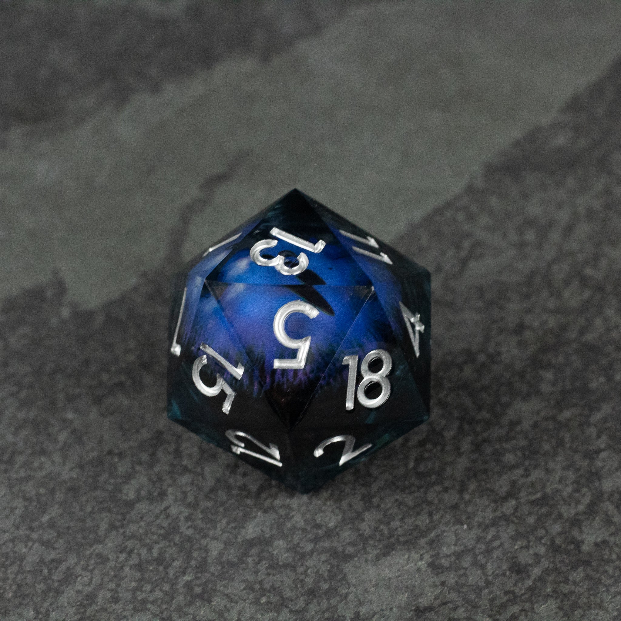 33mm Liquid Floating Eye - Purple - 33mm blue and black d20 die with white numbers and a swirling liquid core design.