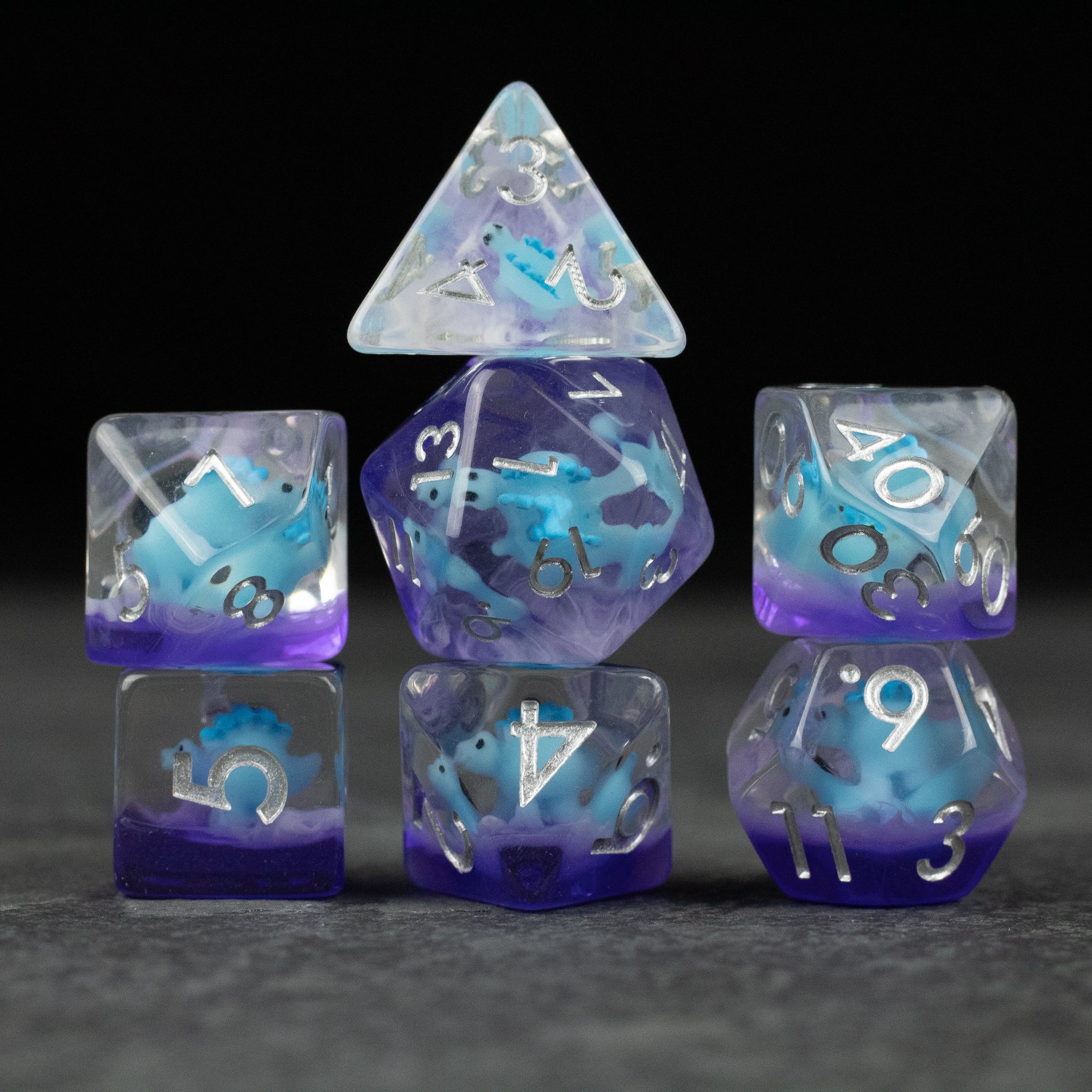 Blue Stegosaurus Dice Set - Blue Stegosaurus-themed translucent polyhedral dice set with white numbering.
