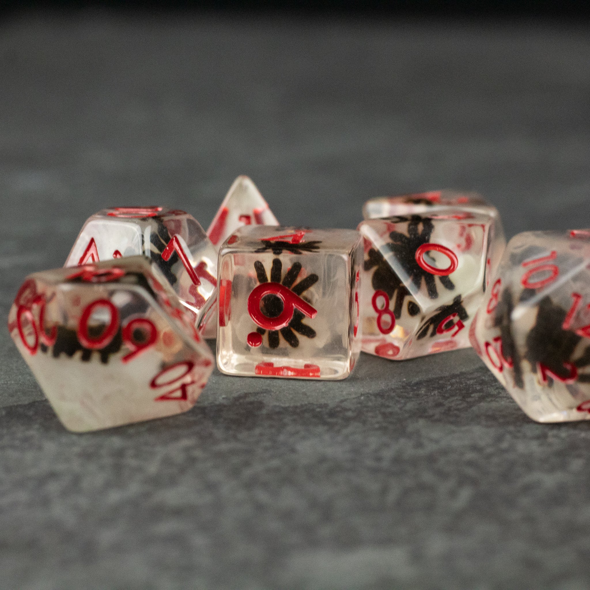Black Spider Dice Set - White - Clear polyhedral dice with black spider designs inside and red numbering.