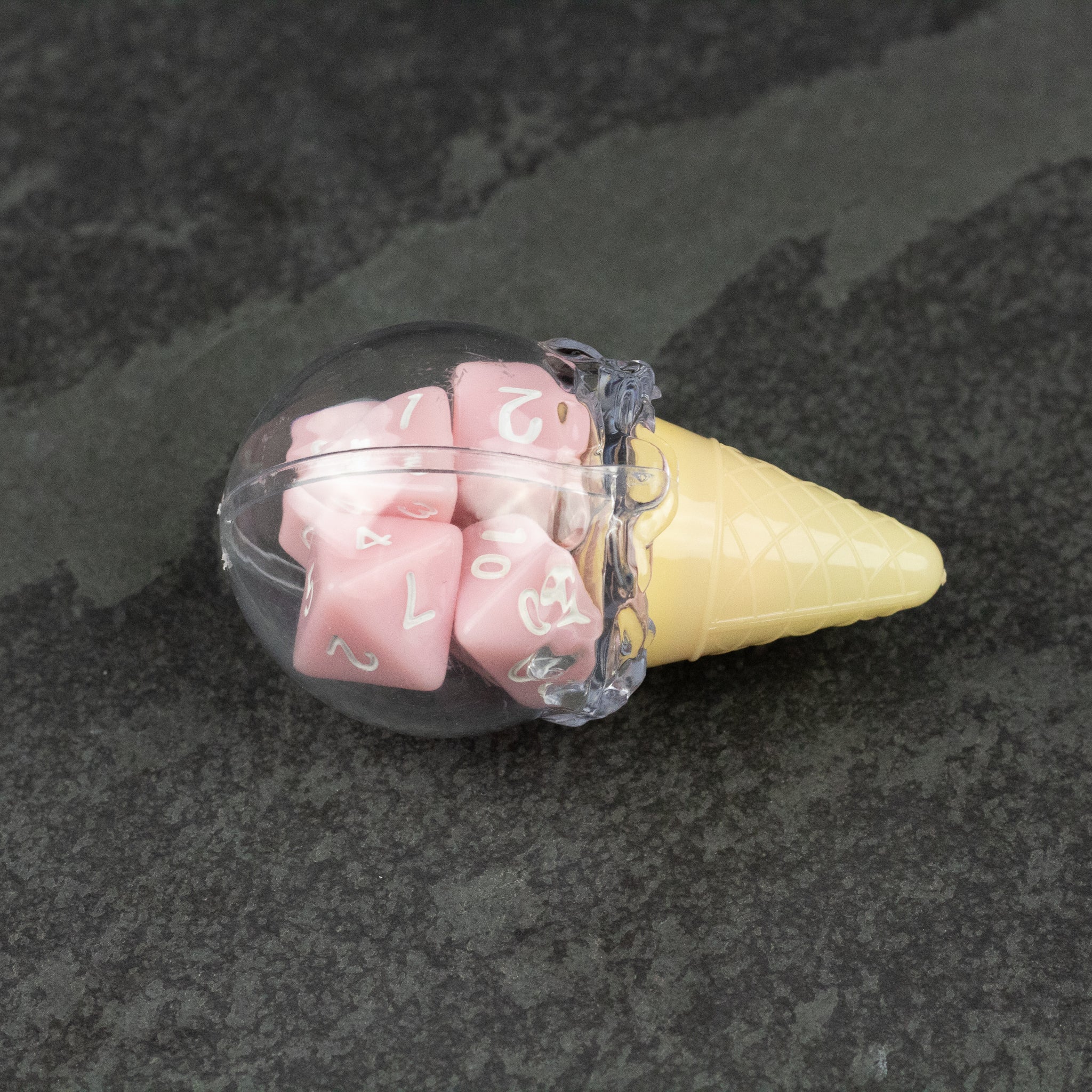 Dice Cream Cones - Clear plastic container shaped like an ice cream cone holding six pink dice with white numbers.