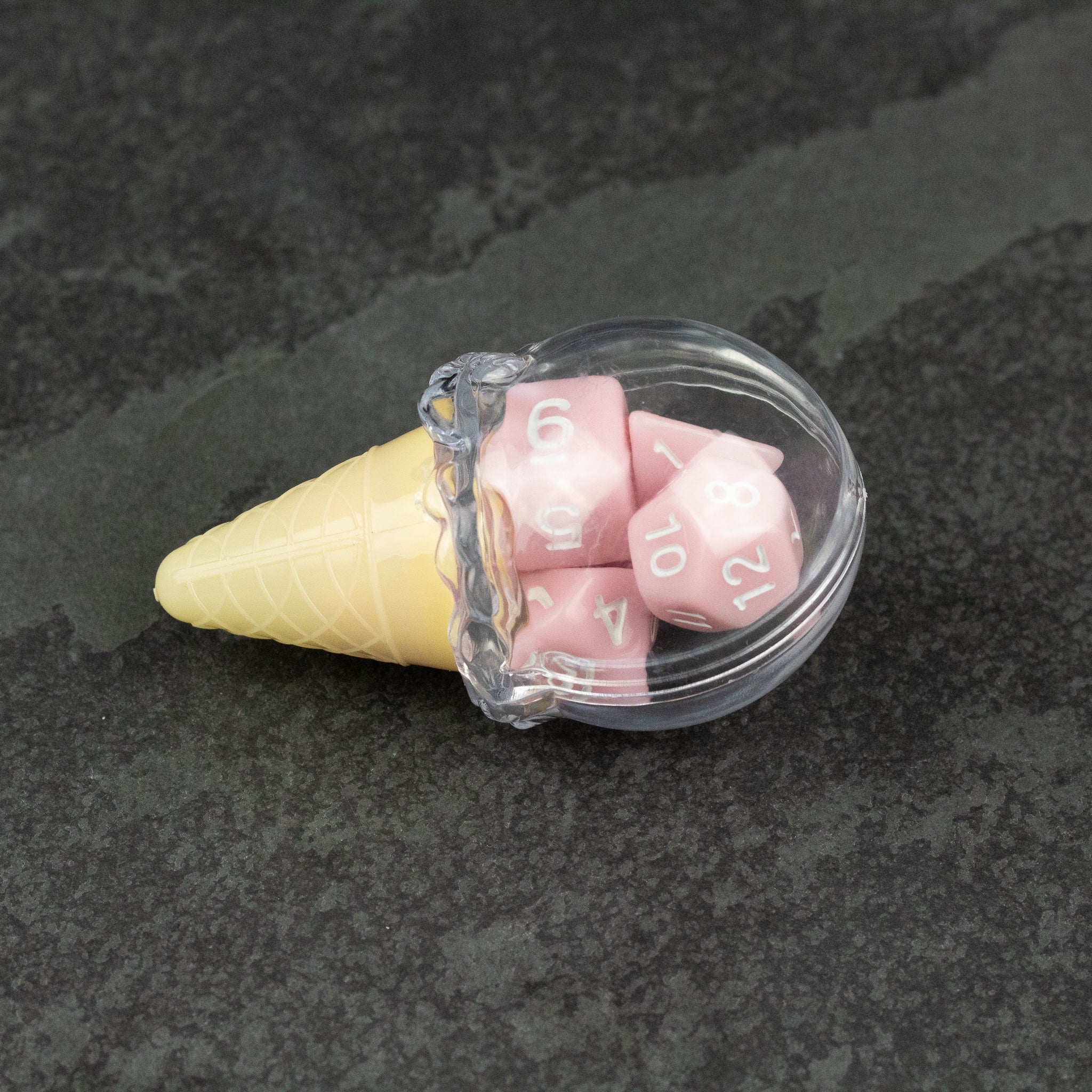 Dice Cream Cones - Yellow waffle cone filled with translucent pink polyhedral dice featuring white numbers.