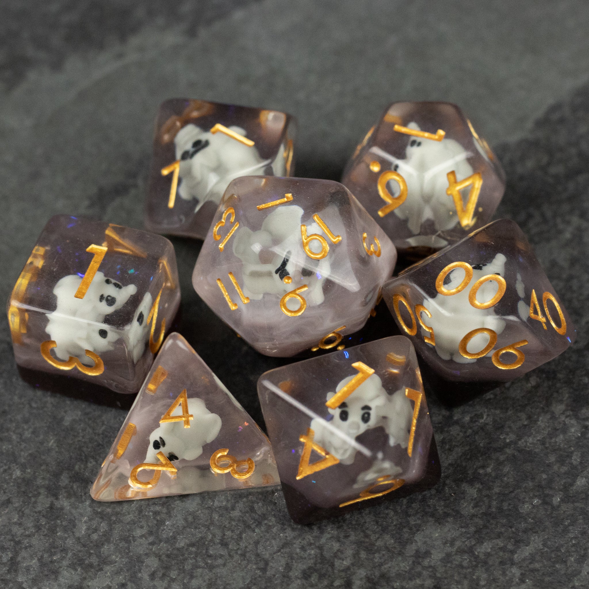 Elephant Dice Set - Translucent brown polyhedral dice set with gold numbers and white elephant silhouettes inside each die.