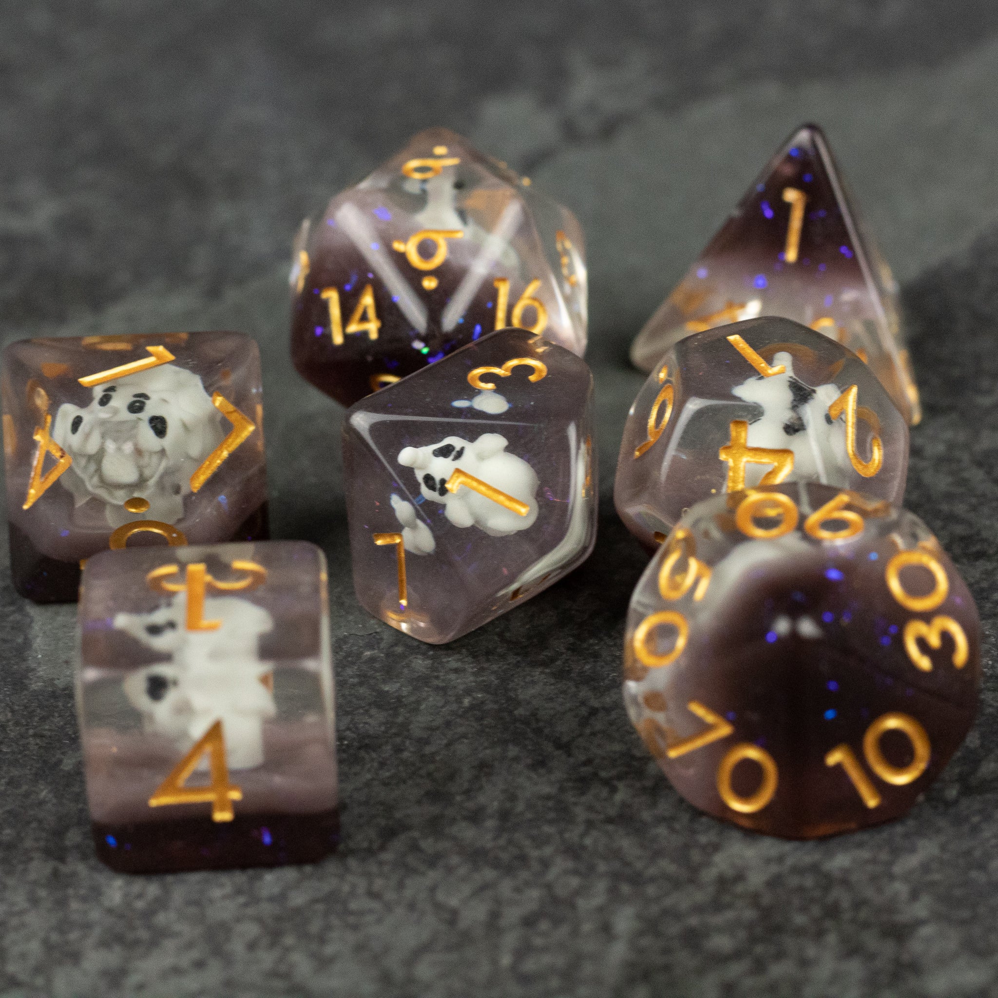 Elephant Dice Set - Purple translucent polyhedral dice set with gold numbers featuring white elephant silhouettes inside.