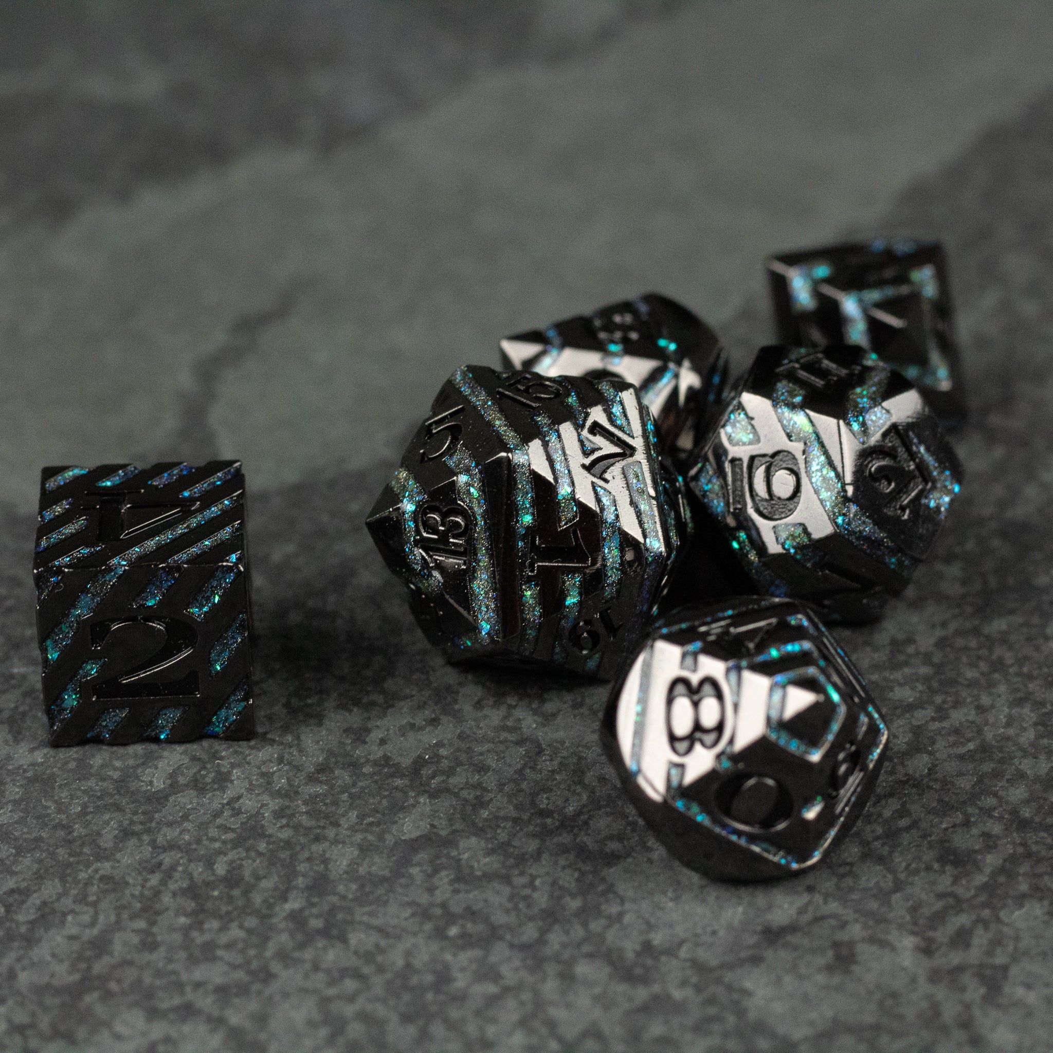 Blue Arcane Leyline Dice Set - Black metal dice set with glowing blue arcane patterns, including multiple polyhedral shapes on a dark surface.