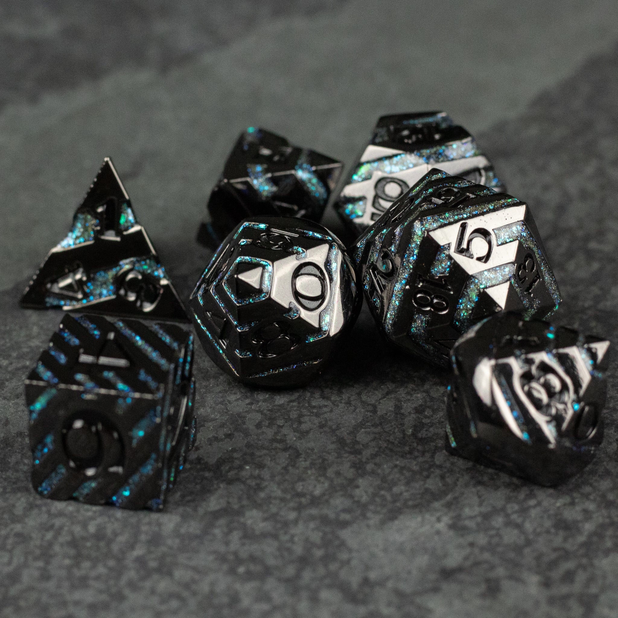 Blue Arcane Leyline Dice Set - Black metal polyhedral dice set with blue lightning patterns and silver numbering on dark textured surface.