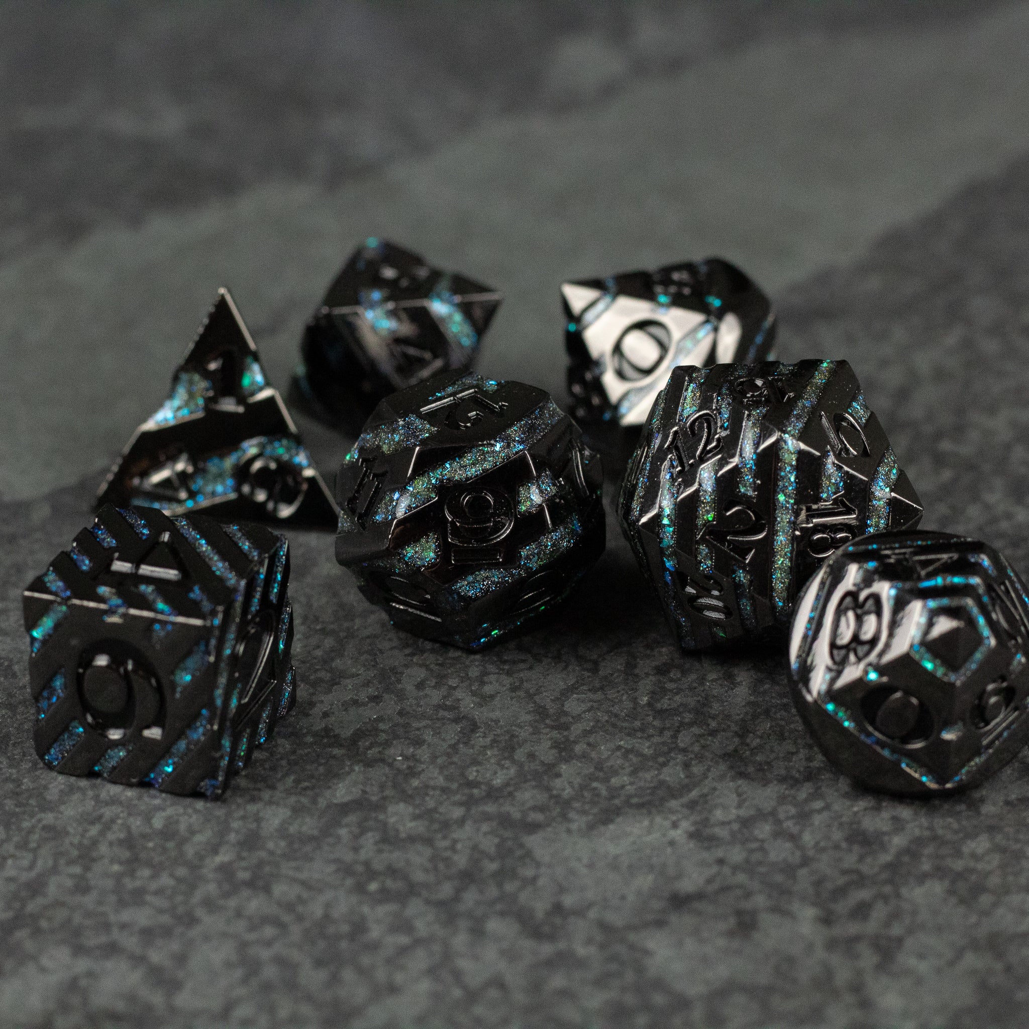 Blue Arcane Leyline Dice Set - Set of seven black metal polyhedral dice with glowing blue arcane patterns and white numbers.