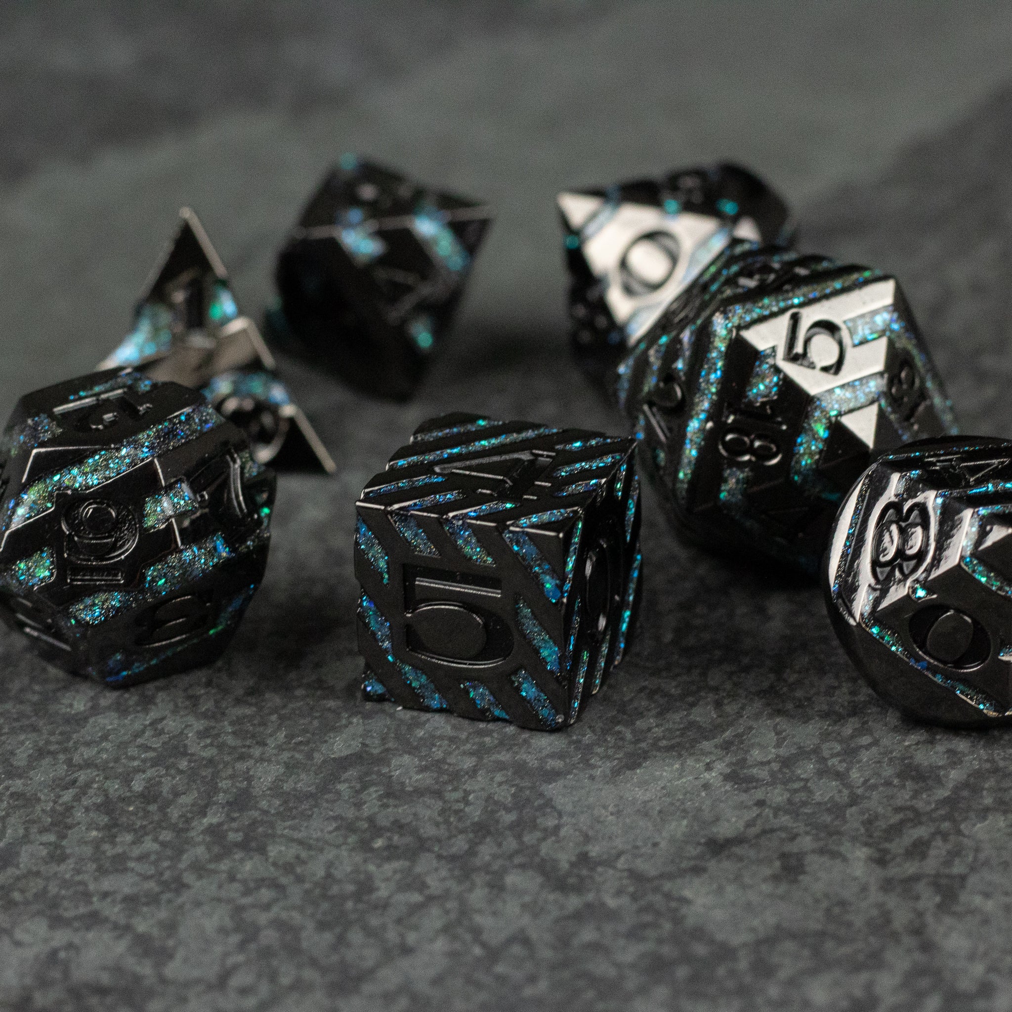 Blue Arcane Leyline Dice Set - Black metal polyhedral dice set with glowing blue arcane vein patterns and silver numbers on textured dark surface.
