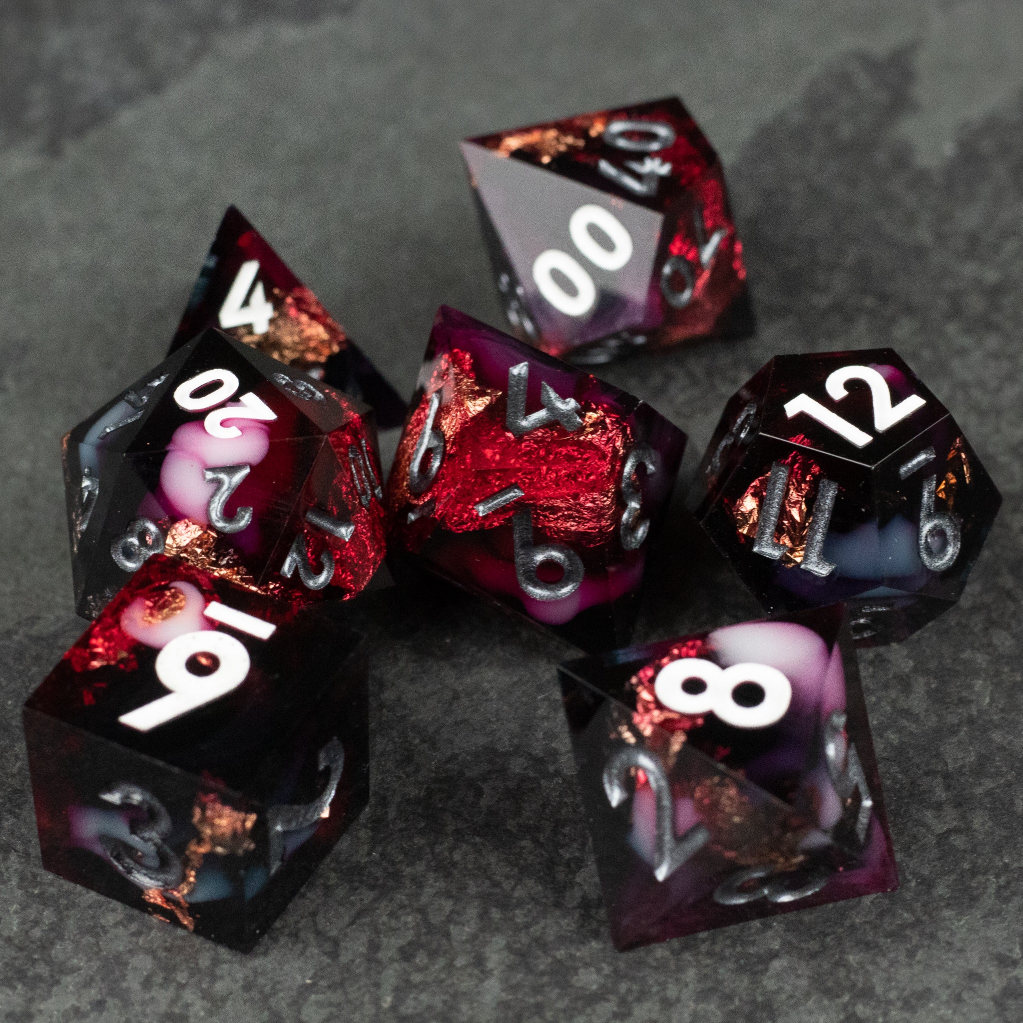 Sanguine Sacrament Dice Set - Seven sharp-edged polyhedral dice in black and deep red with white numbering and copper accents.