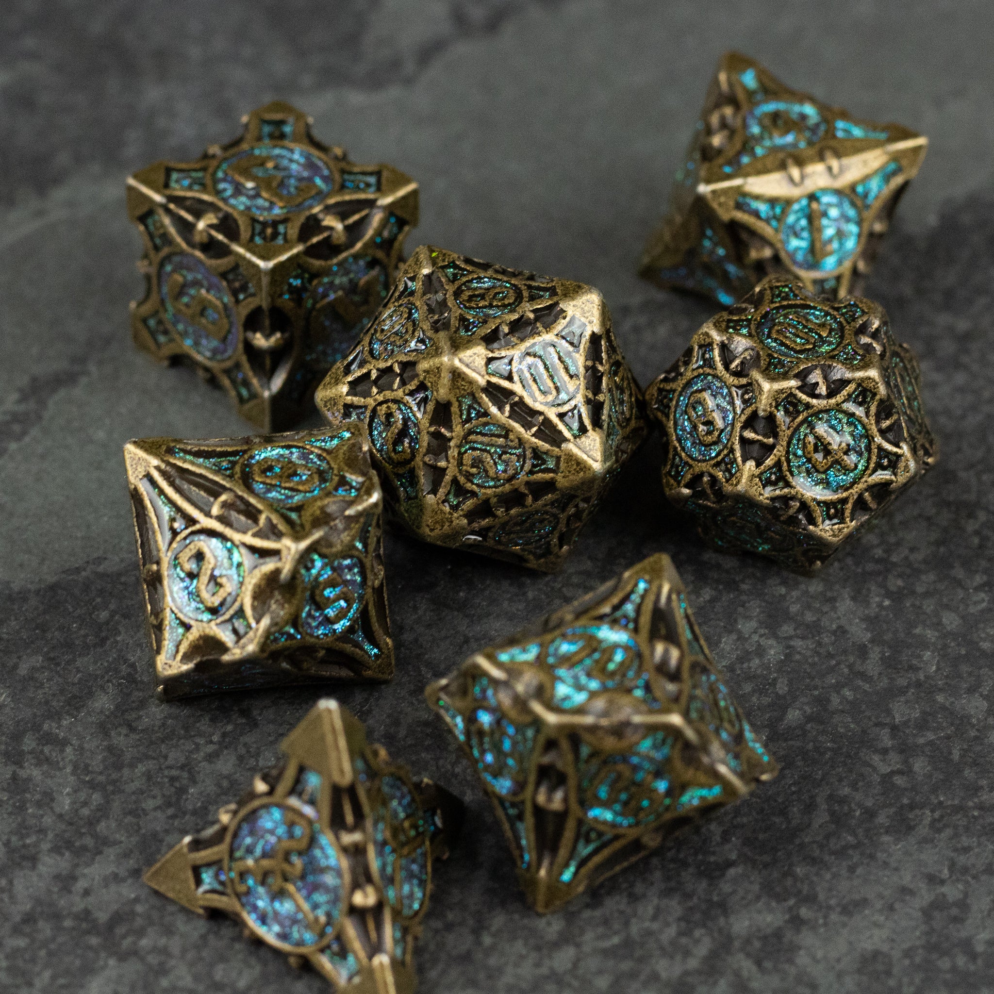 Empyrean Artifact Dice Set - Intricately designed metal dice set with bronze finish and glowing blue filigree details.