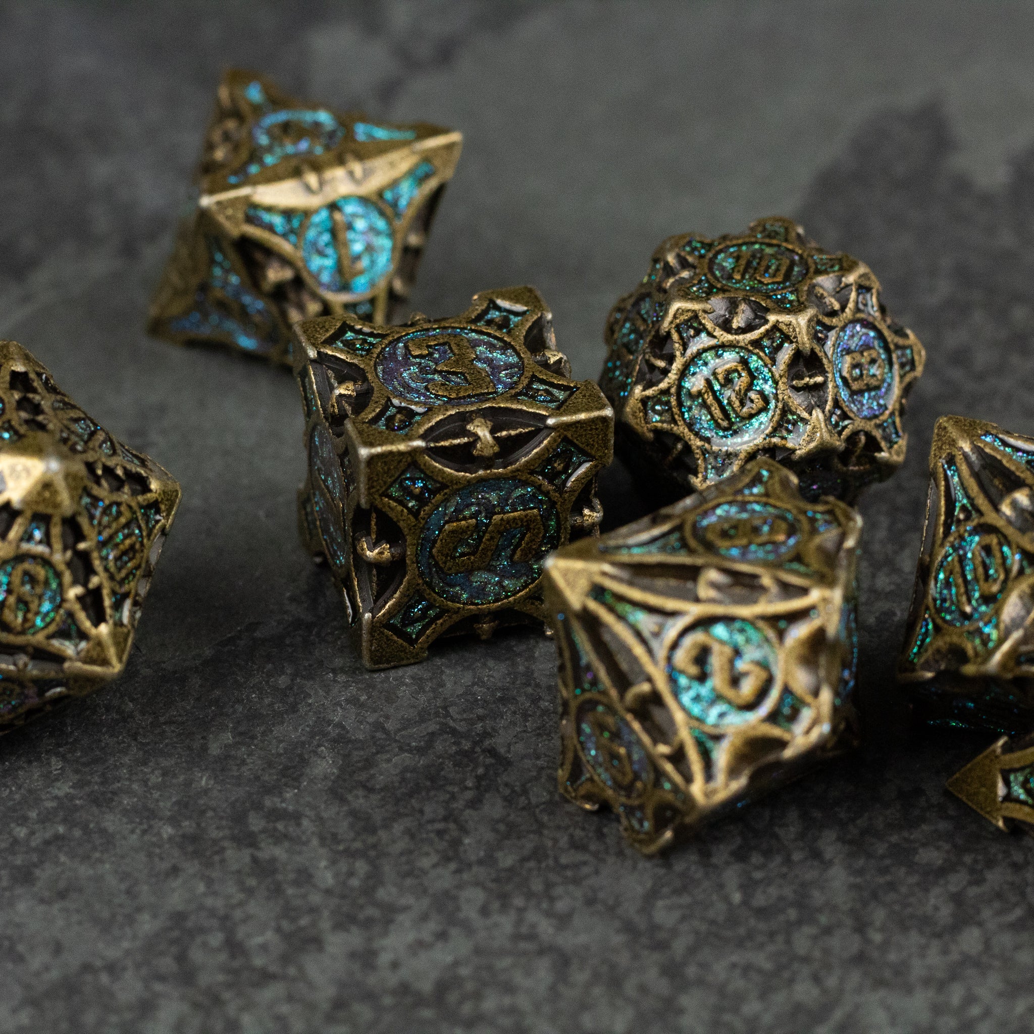 Empyrean Artifact Dice Set - Intricately designed metal dice set with antique gold finish and turquoise inlay, featuring detailed engravings.