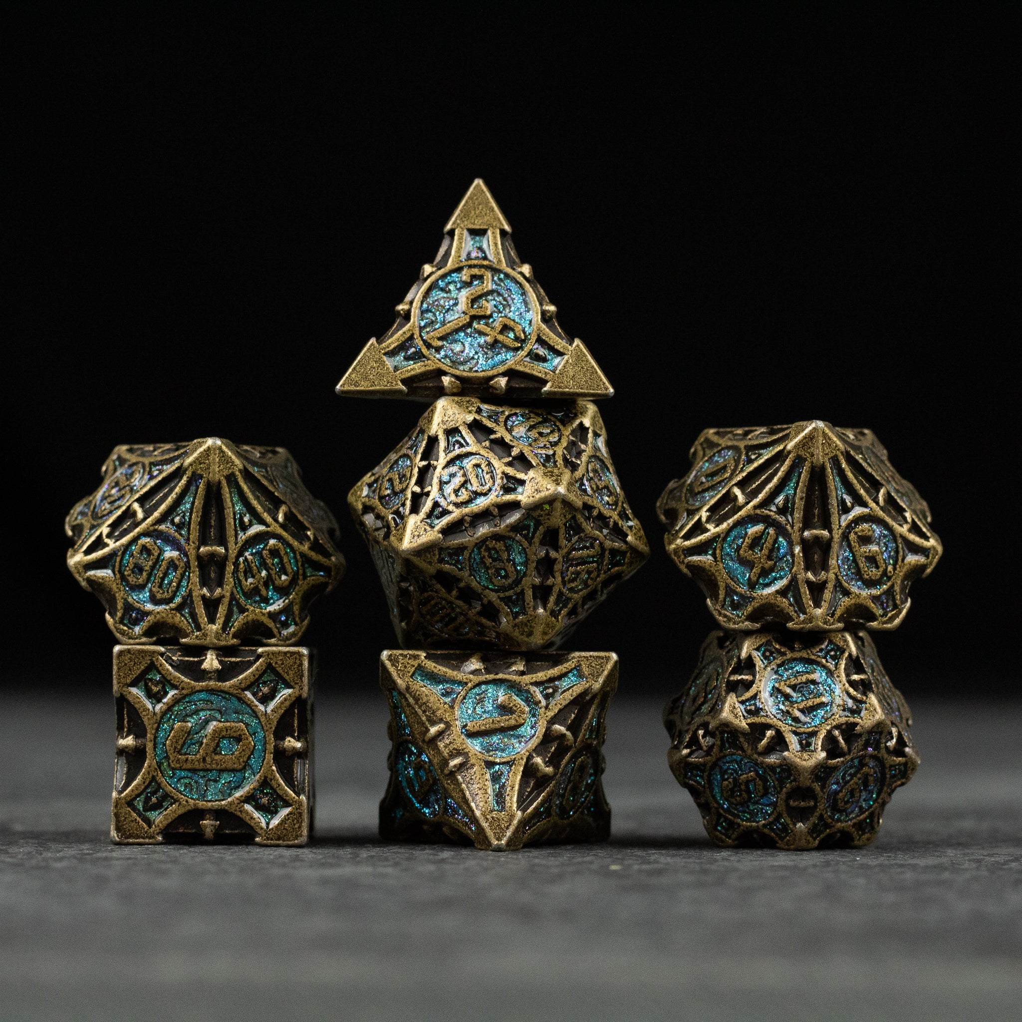 Empyrean Artifact Dice Set - Metallic gold and blue intricately designed seven-piece polyhedral dice set with celestial motifs.