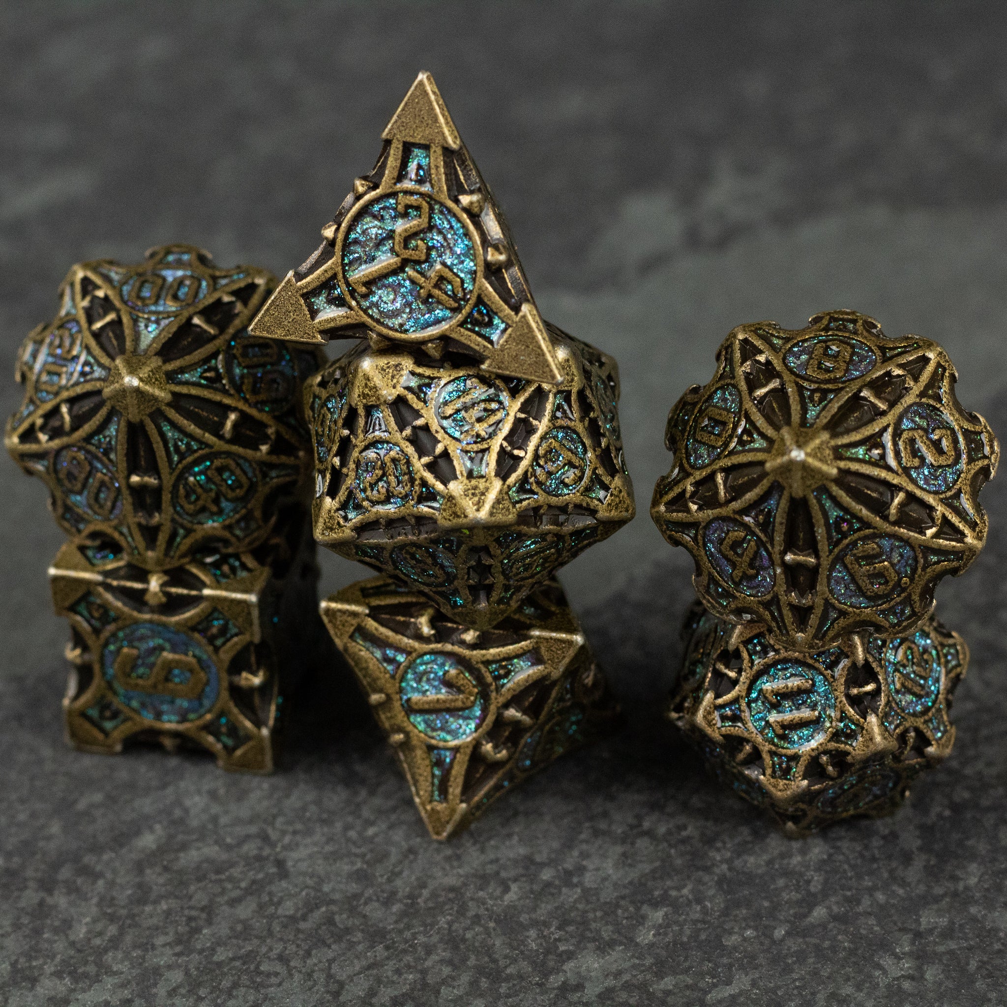 Empyrean Artifact Dice Set - Intricate metal dice set with antique bronze finish and turquoise enamel accents, featuring geometric cutouts and ornate.