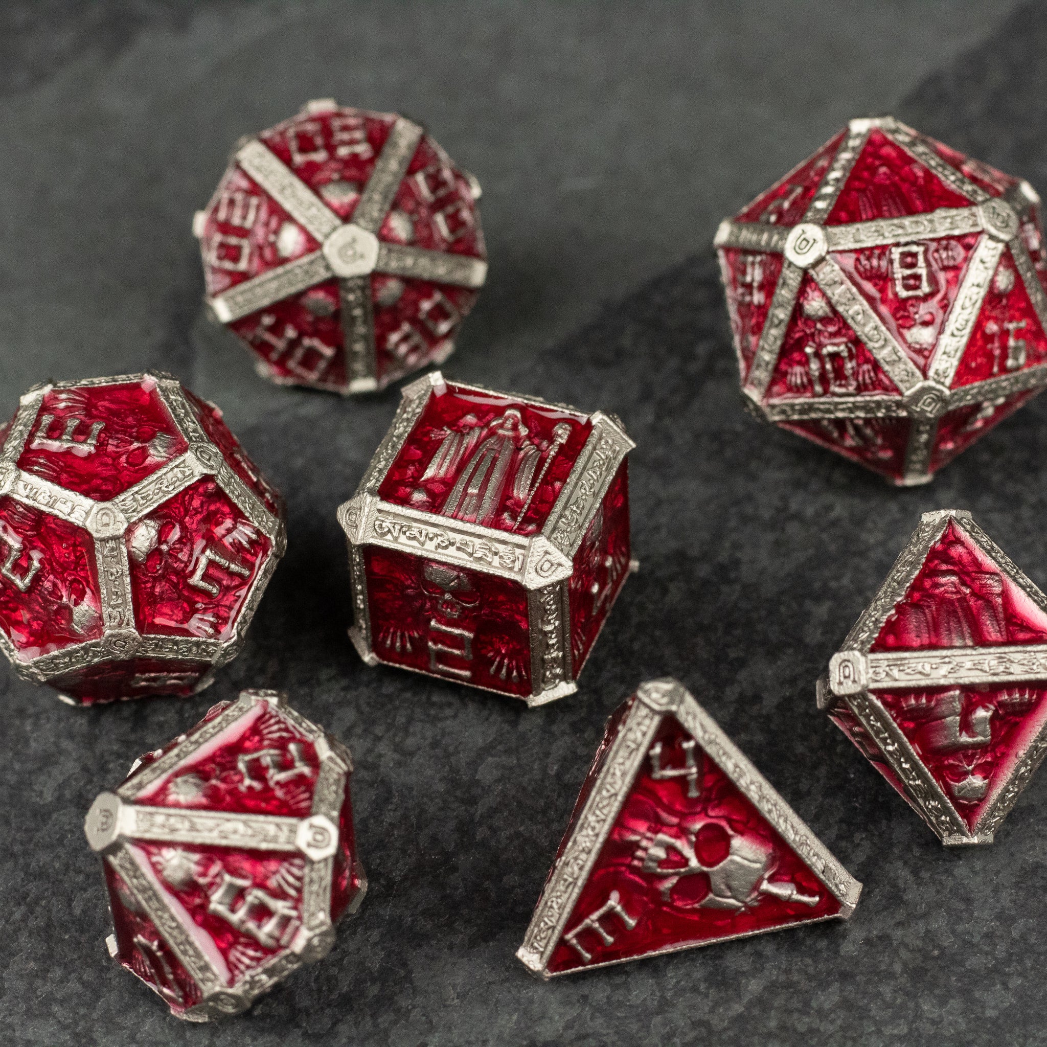 Red Necromancer Metal Dice Set - Red metal dice set with intricate necromancer-themed engravings and silver detailing.