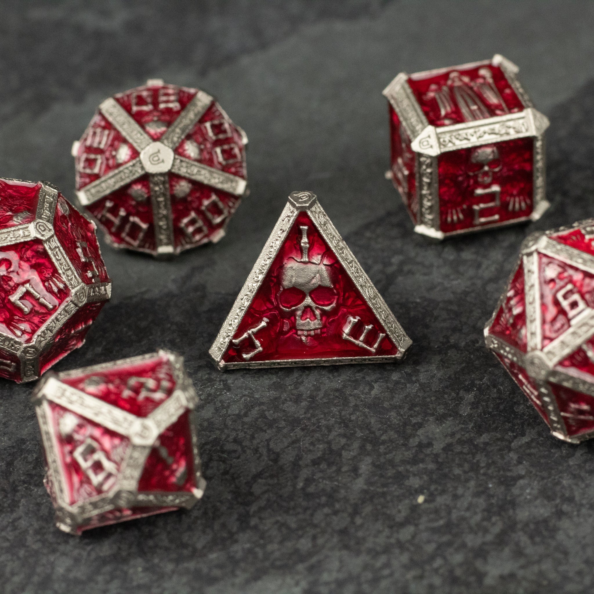 Red Necromancer Metal Dice Set - Red metal necromancer-themed dice set with skull and rune engravings on dark background.