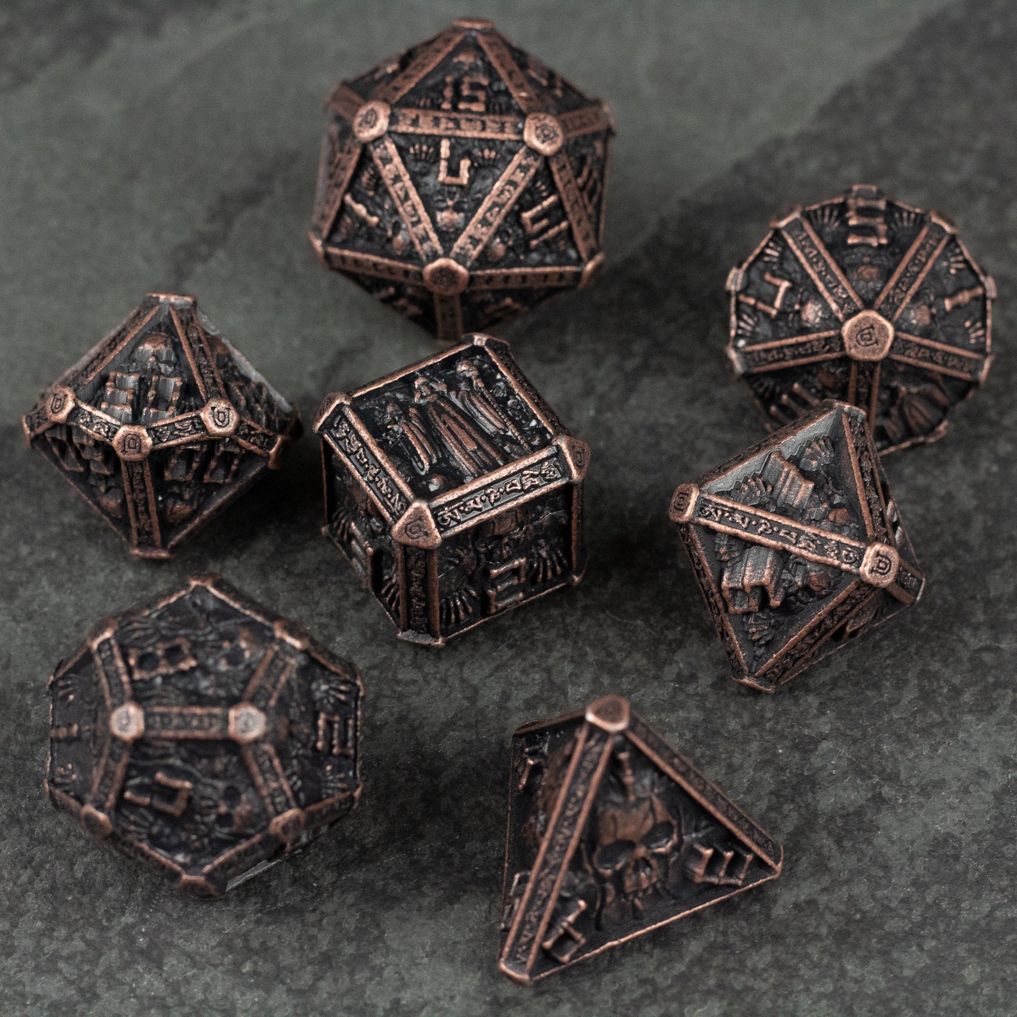 Bronze Necromancer Metal Dice Set - Bronze metal polyhedral dice set with necromancer-themed engravings on stone background.