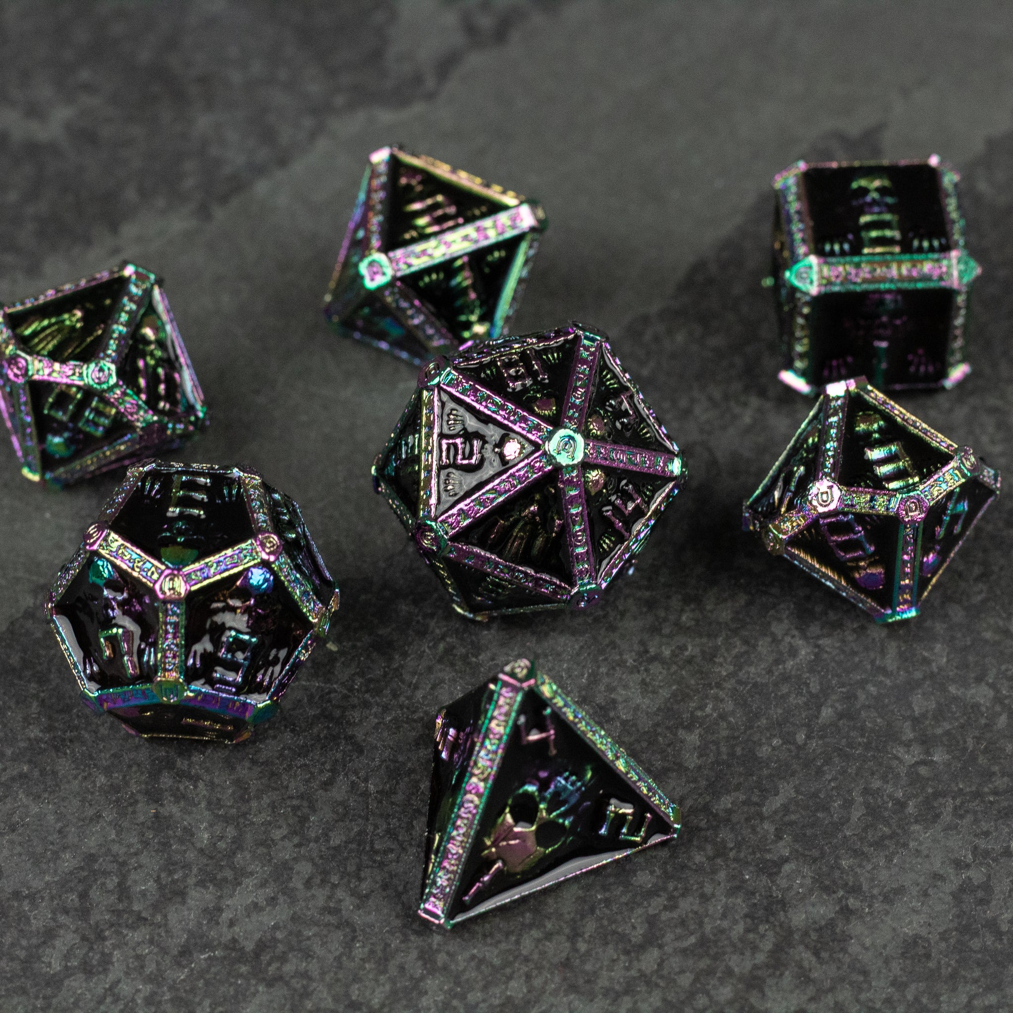 Anodized Necromancer Metal Dice Set - Anodized black metal necromancer dice set with green and purple iridescent edges on dark surface.