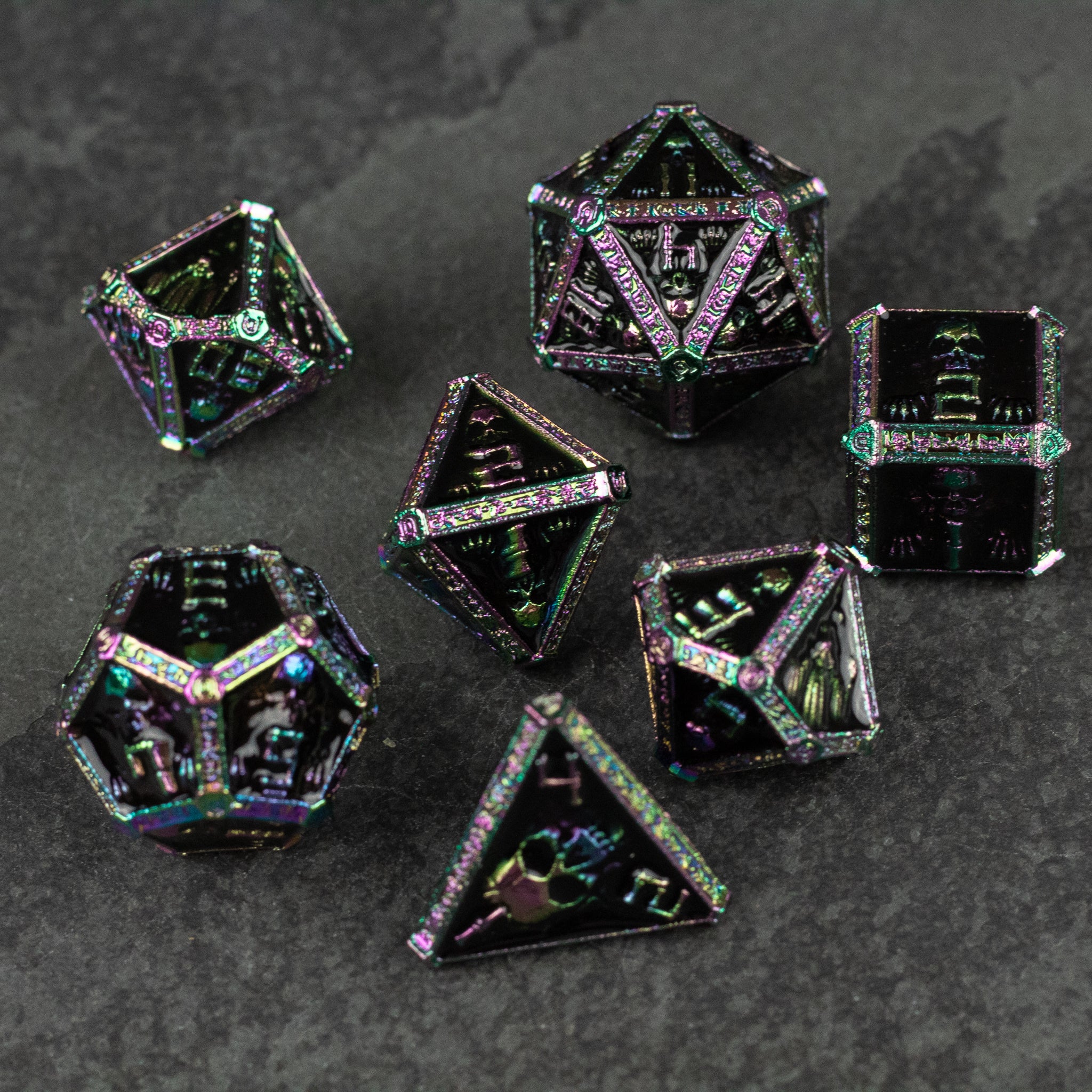 Anodized Necromancer Metal Dice Set - Seven-piece anodized metal dice set with iridescent dark purple and green hues, featuring sharp edges and engraved numbers.