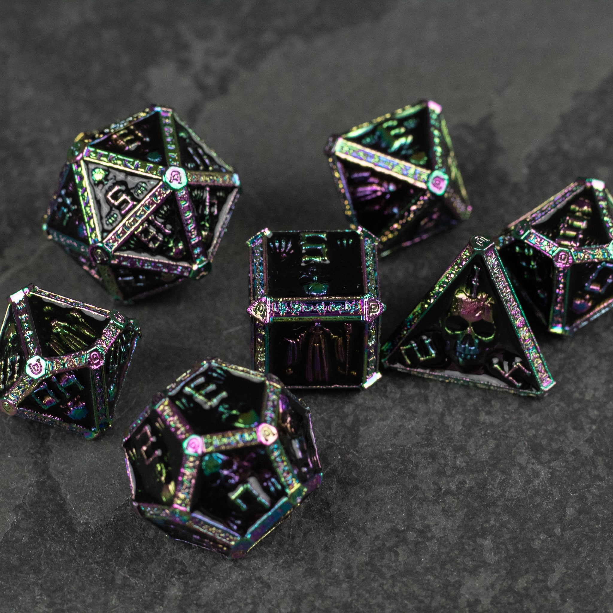 Anodized Necromancer Metal Dice Set - Set of anodized black metal polyhedral dice with iridescent green and purple highlights and white etched numerals.