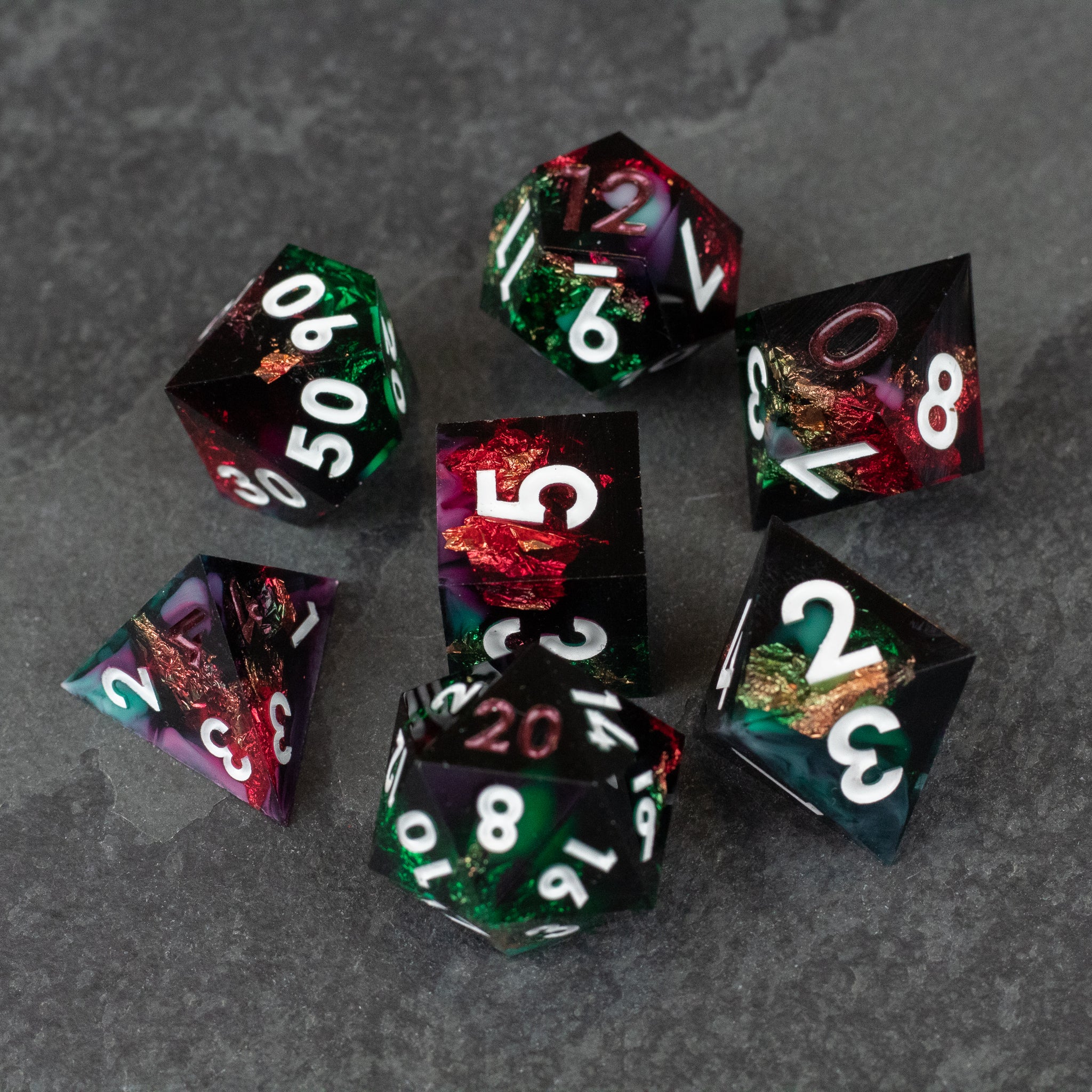 Chromatic Aberration Dice Set - Seven sharp-edged polyhedral dice with colorful chromatic aberration effect and white numbers on dark backgrounds.