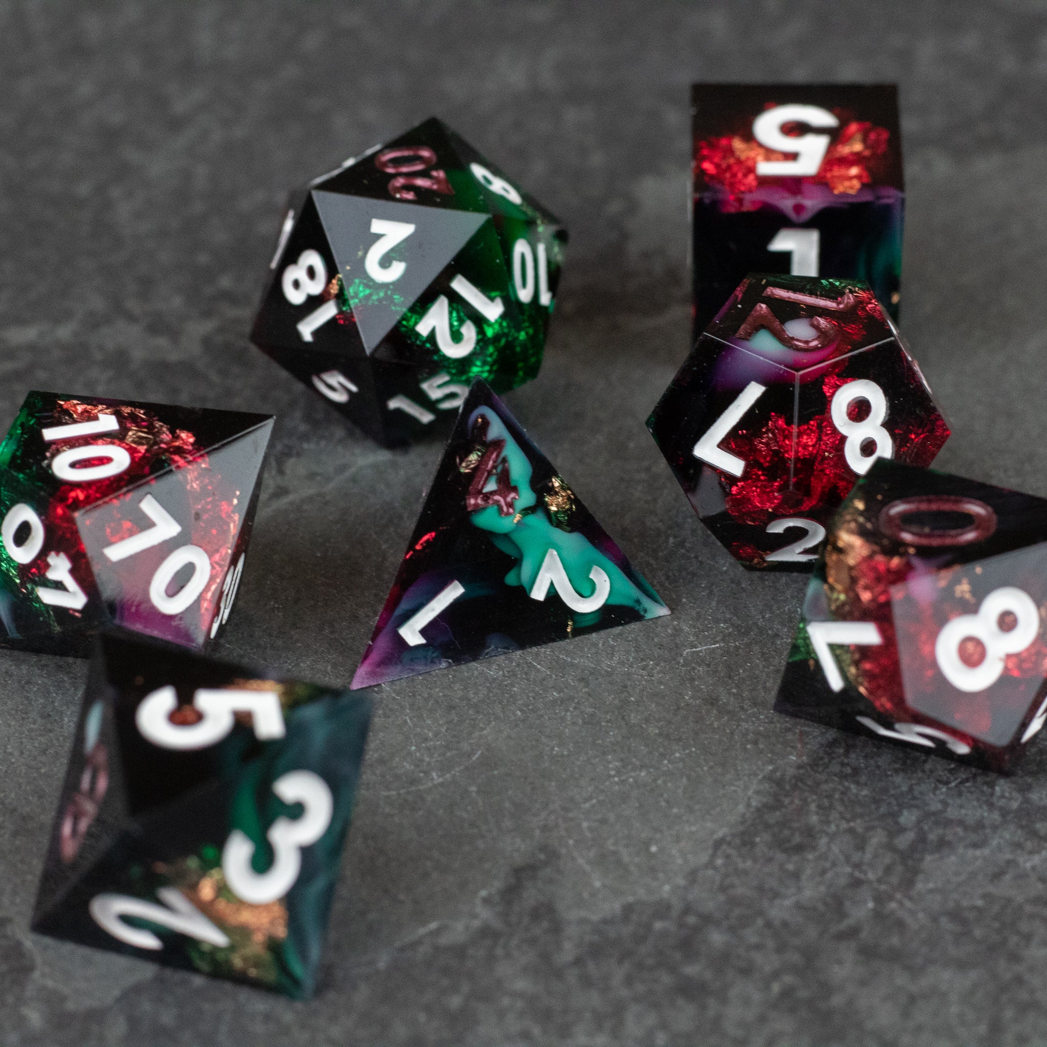 Chromatic Aberration Dice Set - Set of seven sharp-edged polyhedral dice with glossy black bases and multicolor chromatic swirls, white numbers.