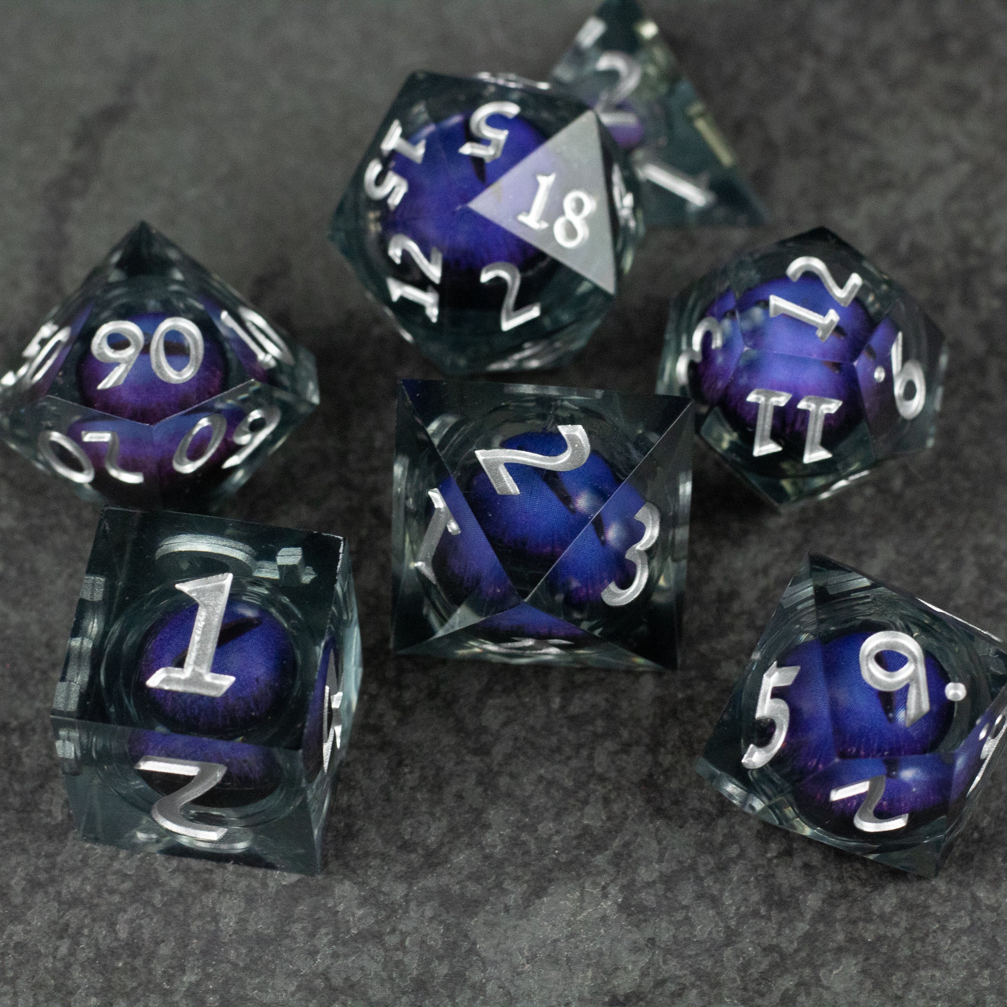 Purple Beholder's Eye Dice Set - Set of seven sharp-edged polyhedral dice with a liquid-core swirling purple and black design, white numbering.