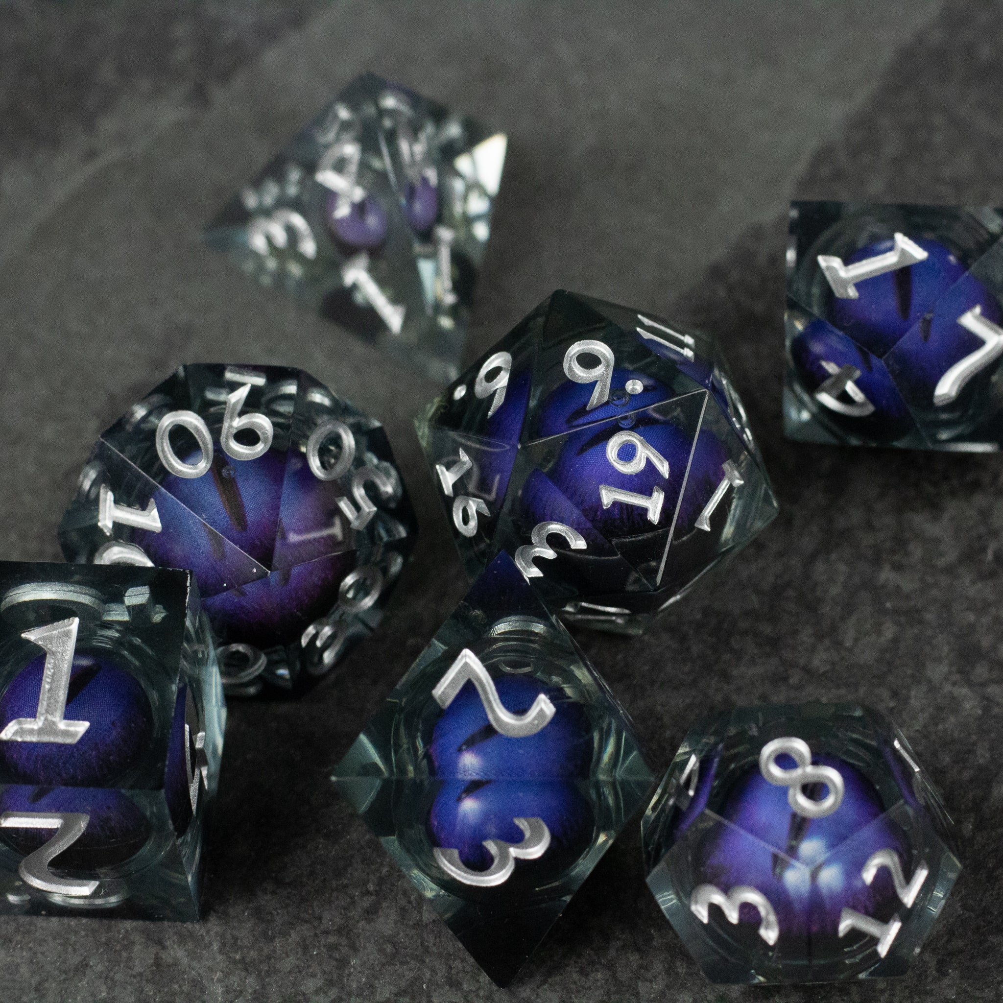 Purple Beholder's Eye Dice Set - Set of seven sharp-edged dice with deep purple liquid core and white numbering.