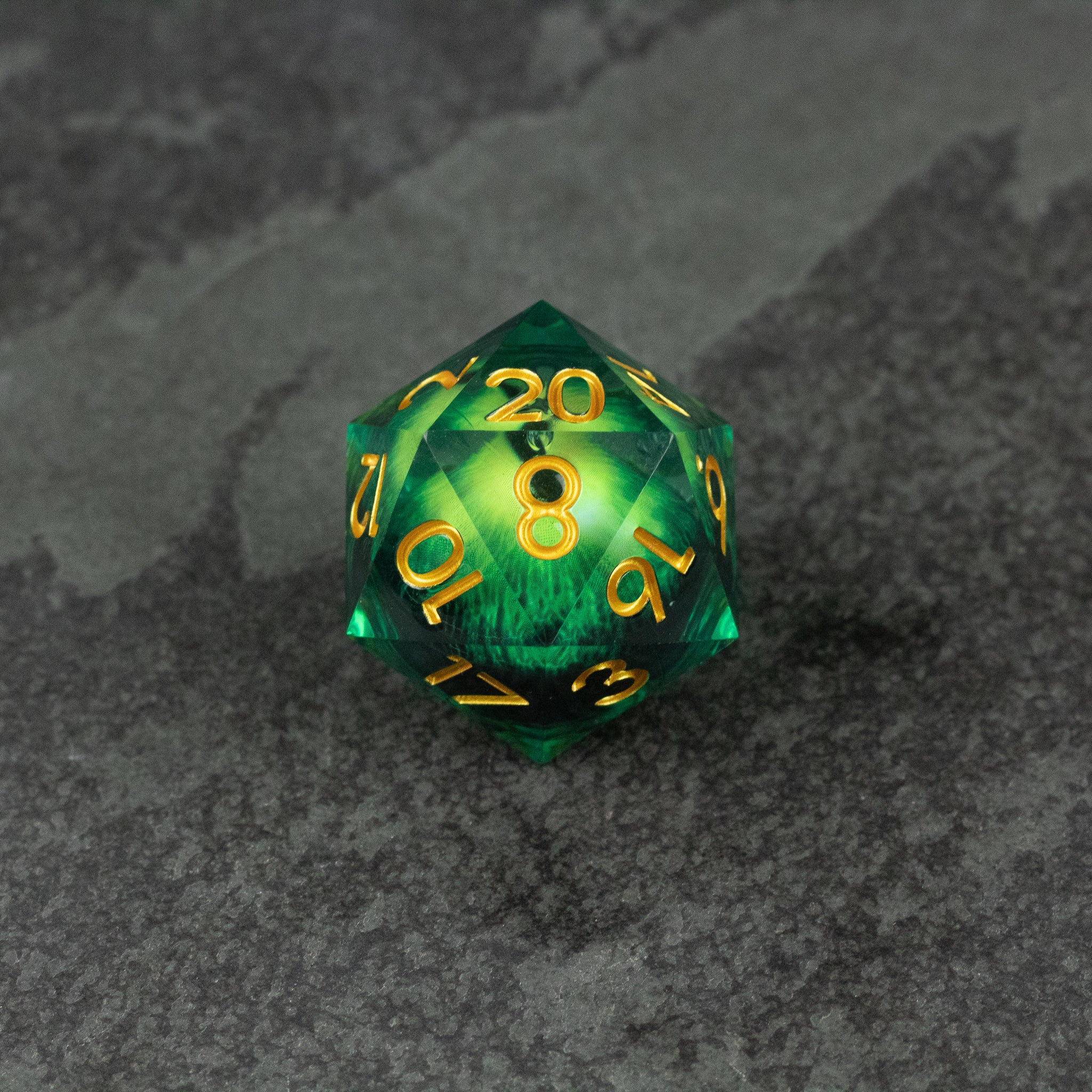33mm Liquid Floating Eye - Green - 33mm green translucent 20-sided die with gold numbering and liquid core floating eye design.