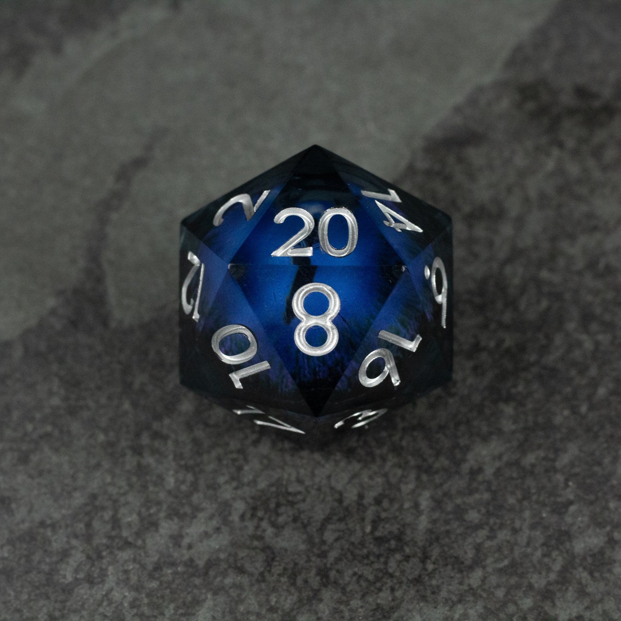 33mm Liquid Floating Eye - Purple - 33mm translucent purple 20-sided dice with white numbers and liquid floating core on dark surface.