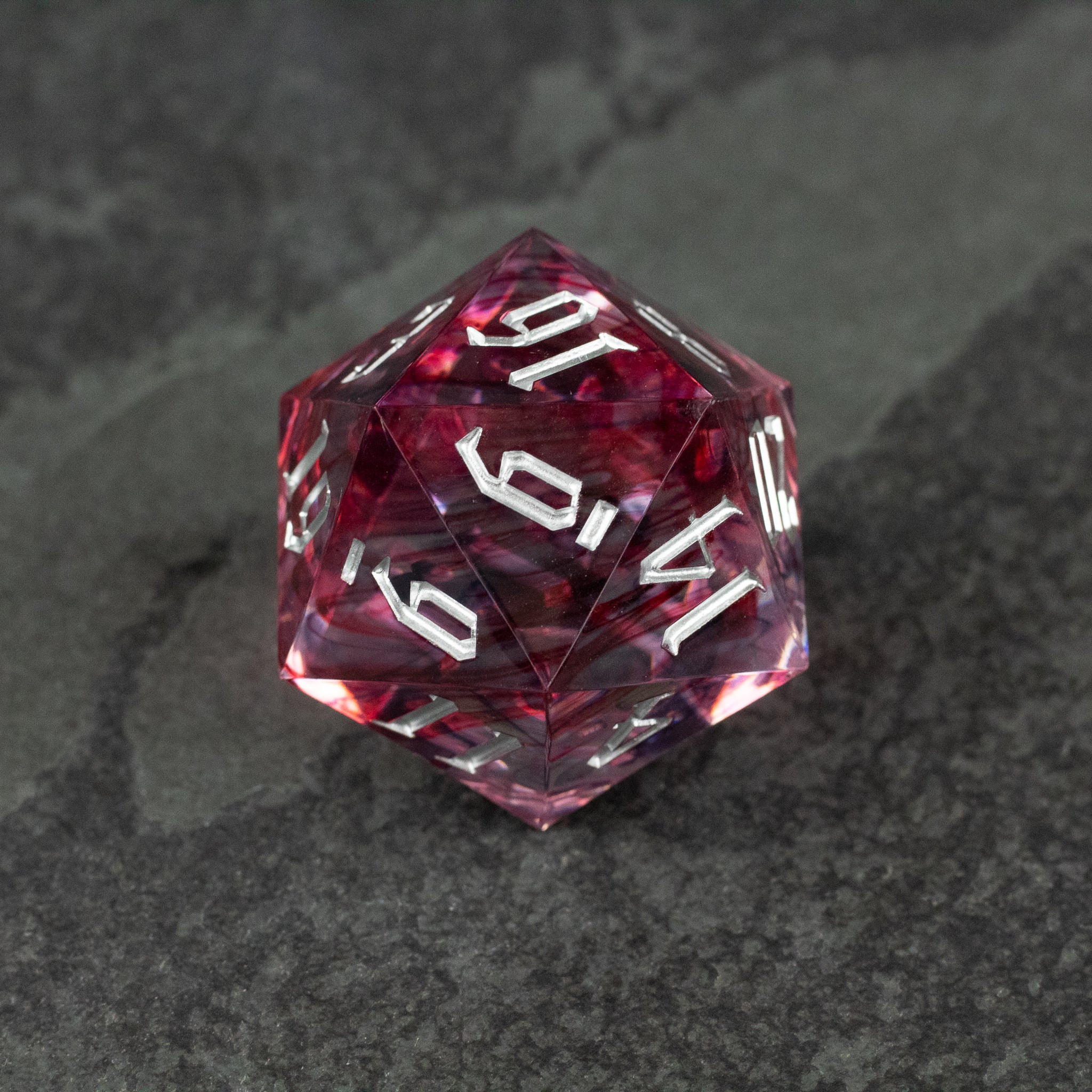 33mm Red Swirl D20 - 33mm translucent red icosahedron D20 dice with white numbering and swirling internal patterns.
