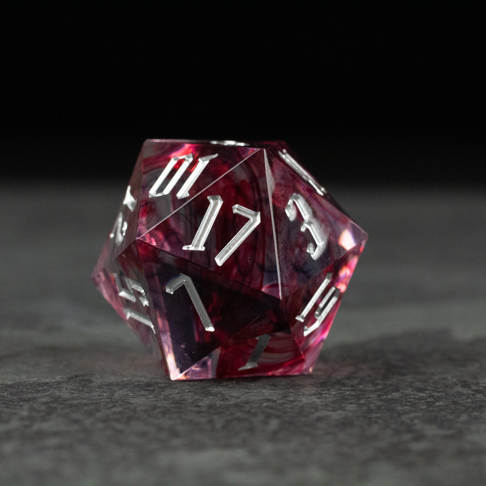 33mm Red Swirl D20 - 33mm red translucent d20 dice with white numbering and swirling pattern inside.