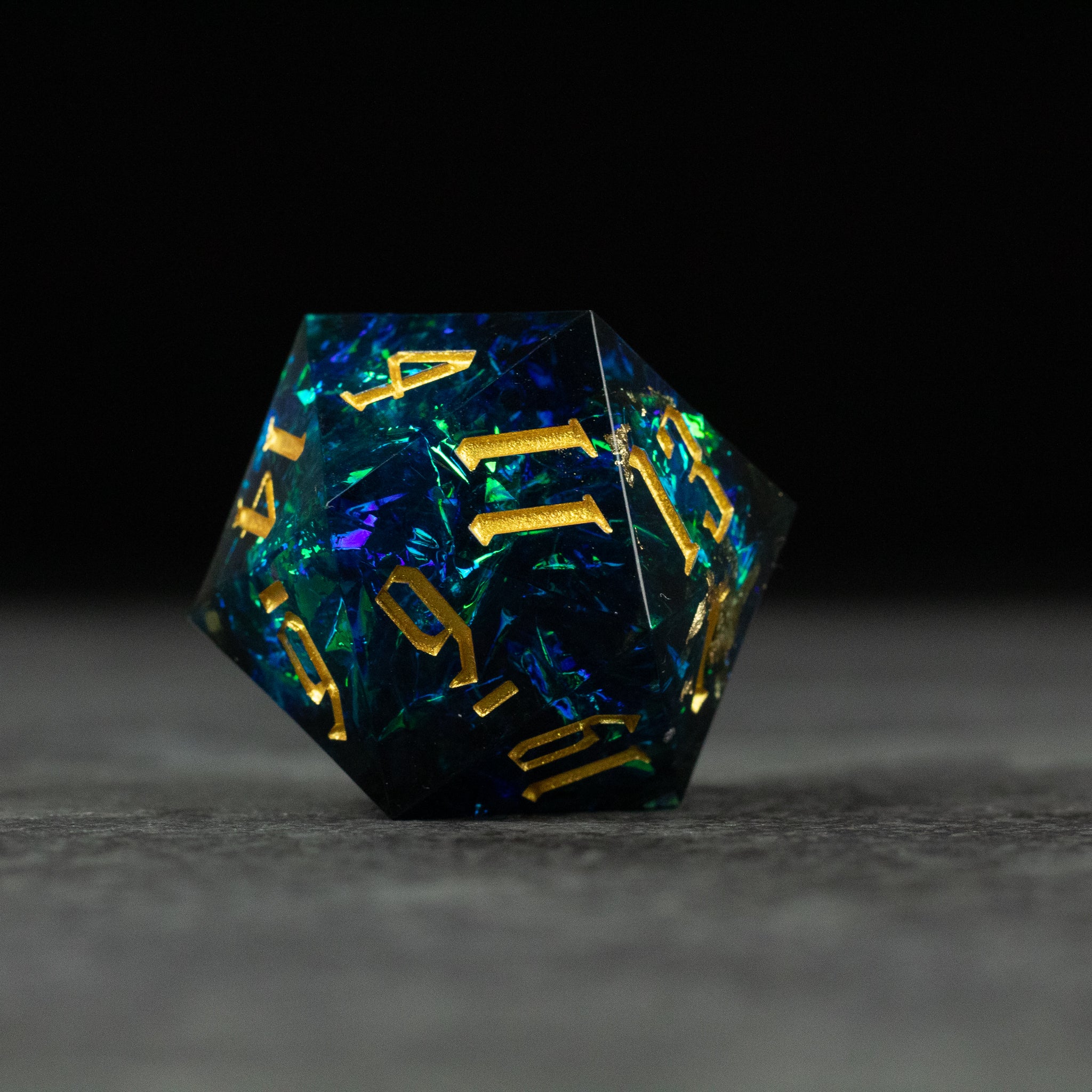 33mm Blue Shimmer D20 - 33mm blue translucent d20 dice with shimmering internal flakes and gold numbers.