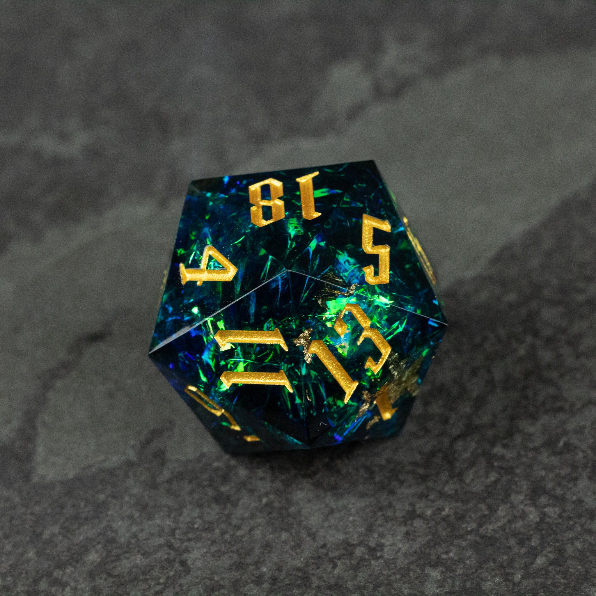 33mm Blue Shimmer D20 - 33mm blue translucent d20 dice with gold numbers and shimmering flecks.