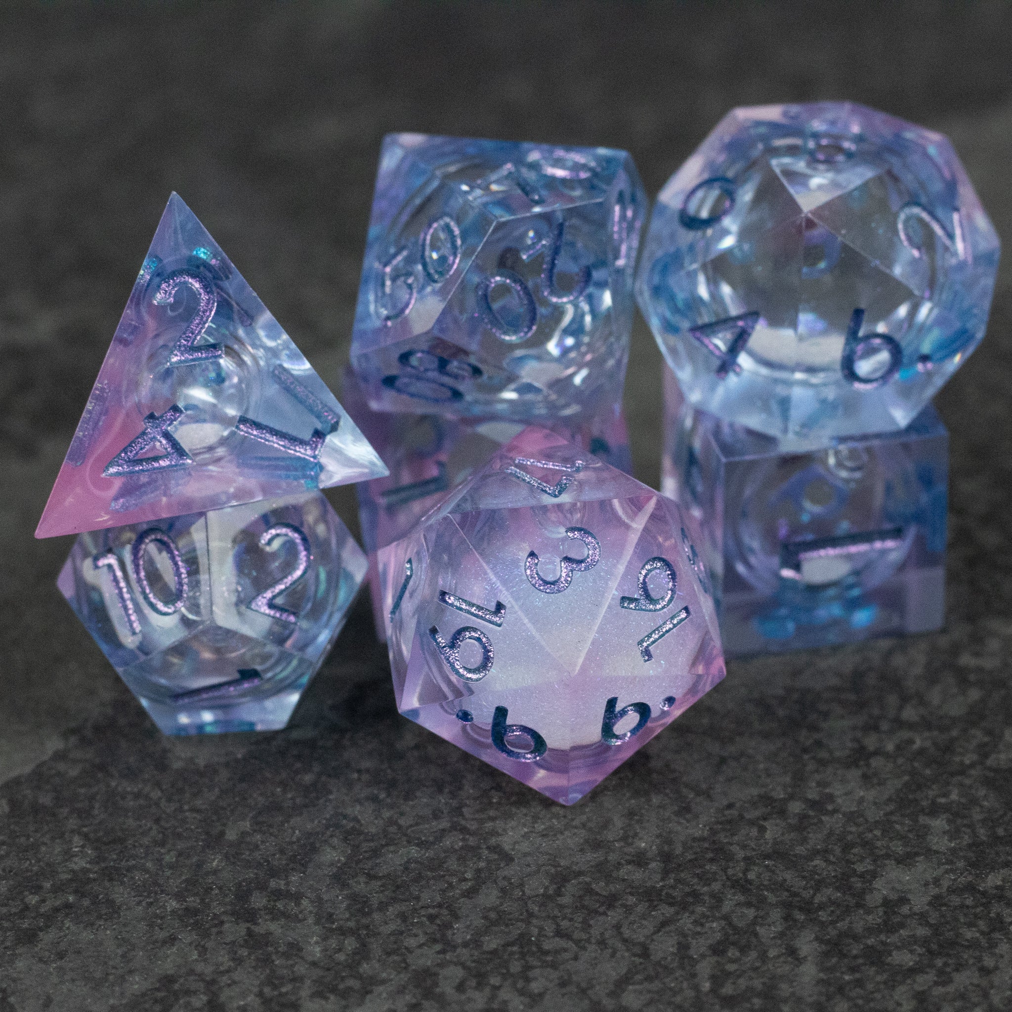 Fae Magic - Liquid Core Dice Set - Set of seven translucent purple and blue polyhedral dice with swirling liquid core and silver numbering, designed for.